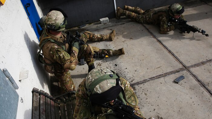Soldiers from the 43rd Georgian Infantry Battalion post security as another soldier attends to a simulated casualty during the Mission Rehearsal Exercise at the Joint Multinational Readiness Center, Hohenfels, Germany, Feb. 22. The Mission Rehearsal Exercise is a month-long culminating event in which soldiers from the 43rd Georgian Infantry Battalion are tested in their abilities before being deployed to Afghanistan.