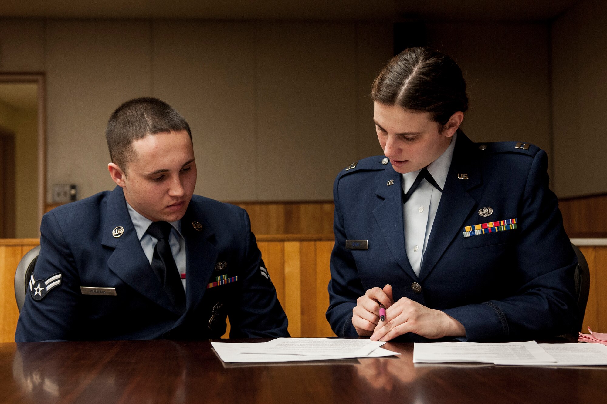 Capt. Erin Kenny (right) advises the alleged perpetrator, Airman 1st Class Adam Arruda,  during a sexual assault mock trial Feb. 24, 2015, at Kunsan Air Base, South Korea. Airmen from the Kunsan AB First Term Airmen Center have the opportunity to witness a realistic portrayal of a sexual assault trial every month. Kenny is an Area Defense Counsel attorney. (U.S. Air Force photo/Senior Airman Katrina Heikkinen)