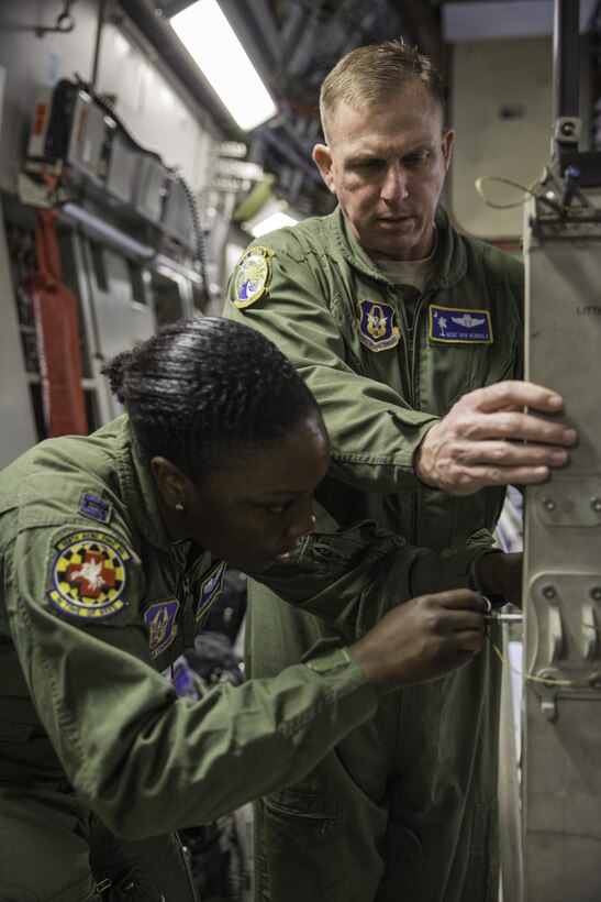 Master Sgt. Ron Newbold helps Capt. Elizabeth Kotey set up a litter stanchion Feb. 22, 2015 during a training mission in San Juan, Puerto Rico. The mission was part of a three day fly-away with Airmen from the 315th Airlift Wing at Joint Base Charleston, South Carolina and aeromedical Airmen from the 459th Air Refueling Wing at Joint Base Andrews, Maryland. The training mission was a cost-effective means to accomplish currency items and evaluations for flight crew members and provided C-17 familiarization and proficiency training for aeromedical Airmen. Newbold is a loadmaster with the 300th Airlift Squadron and Kotey is a flight nurses with the 459th Aeromedical Evacuation Squadron (U.S. Air Force Photo/Tech. Sgt. Shane Ellis)
