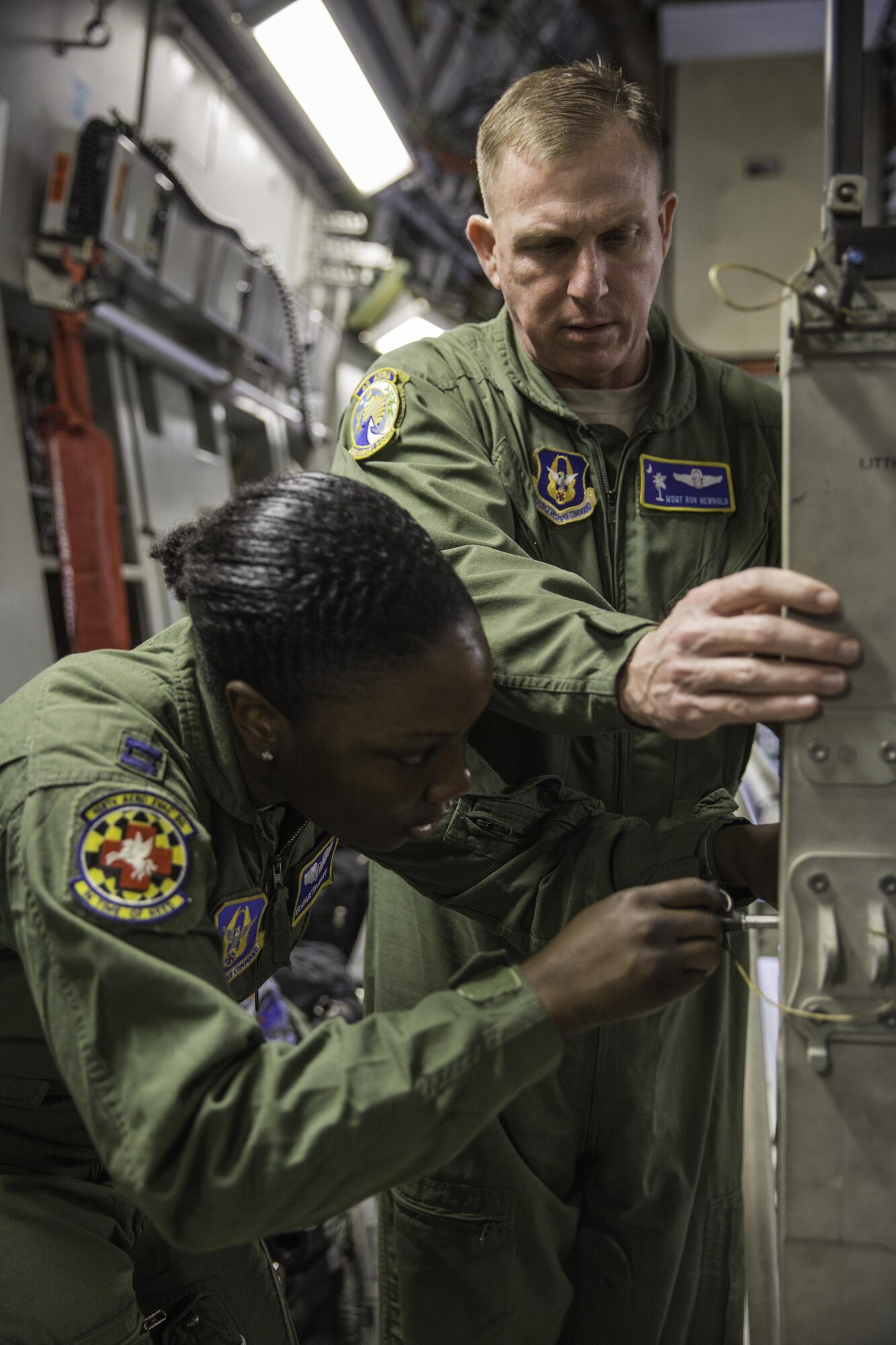 Master Sgt. Ron Newbold helps Capt. Elizabeth Kotey set up a litter stanchion Feb. 22, 2015 during a training mission in San Juan, Puerto Rico. The mission was part of a three day fly-away with Airmen from the 315th Airlift Wing at Joint Base Charleston, South Carolina and aeromedical Airmen from the 459th Air Refueling Wing at Joint Base Andrews, Maryland. The training mission was a cost-effective means to accomplish currency items and evaluations for flight crew members and provided C-17 familiarization and proficiency training for aeromedical Airmen. Newbold is a loadmaster with the 300th Airlift Squadron and Kotey is a flight nurses with the 459th Aeromedical Evacuation Squadron (U.S. Air Force Photo/Tech. Sgt. Shane Ellis)
