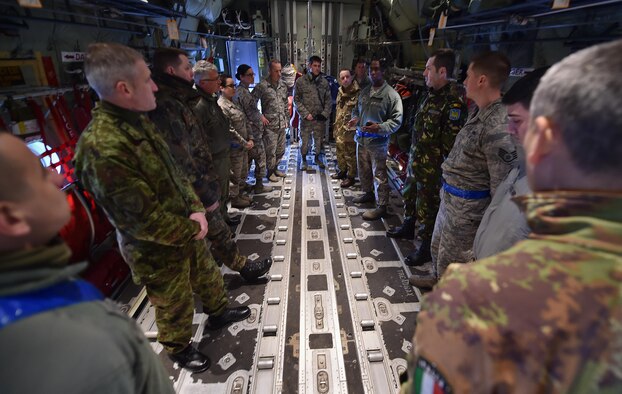 Tech. Sgt. James Shanks and Tech. Sgt. Chris Willingham brief a group of enlisted leaders from six different nations’ air forces throughout Europe about the 86th Aircraft Maintenance Squadron mission inside a C-130J Hercules Feb. 23, 2015, at Ramstein Air Base, Germany. The group of enlisted leaders including the chief master sergeant of the Romanian and Estonian air forces and other leaders from the German, Italian, Slovenian and the U.K.’s air forces visited Ramstein AB before attending the Kaiserslautern Military Community First Sergeant Council's First Sergeant Symposium. Shanks and Willingham are both assigned to the 86th AMXS. (U.S. Air Force photo/Staff Sgt. Sara Keller)