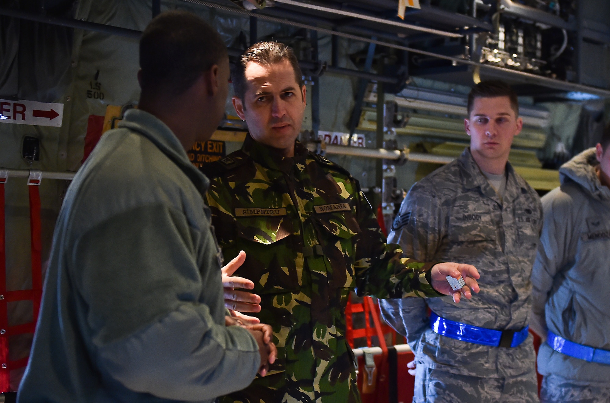 Chief Master Sgt. of the Romanian Air Force Daniel Simpetru discusses the capabilities of a C-130J Hercules with Tech. Sgt. Chris Willingham Feb. 23, 2015, at Ramstein Air Base, Germany. A group of enlisted leaders included the chief master sergeant of the Romanian and Estonian air forces and other leaders from the German, Italian, Slovenian and the U.K.’s air forces visited Ramstein AB before attending the Kaiserslautern Military Community First Sergeant Council's First Sergeant Symposium. Willingham is assigned to the 86th Aircraft Maintenance Squadron. (U.S. Air Force photo/Staff Sgt. Sara Keller)