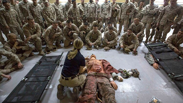 Marines with India Company, Battalion Landing Team 3rd Battalion, 6th Marine Regiment, 24th Marine Expeditionary Unit, receive a demonstration on  casualty aid during combat life saver training at Camp Buehring, Kuwait, Feb. 2, 2015. A contingent of 24th MEU Marines is conducting scheduled sustainment training in Kuwait. The 24th MEU is embarked on the ships of the Iwo Jima Amphibious Ready Group and deployed to maintain regional security in the U.S. 5th Fleet area of operations.