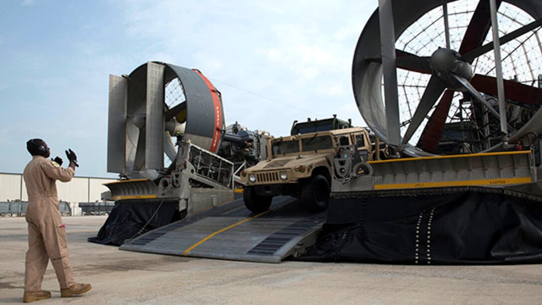 A Marine with the  24th Marine Expeditionary Unit guides a Humvee off a Landing Craft, Air Cushioned vessel in Kuwait,  Jan. 31, 2015. A contingent of 24th MEU Marines is conducting scheduled sustainment training in Kuwait. The 24th MEU is embarked on the ships of the Iwo Jima Amphibious Ready Group and deployed to maintain regional security in the U.S. 5th Fleet area of operations.