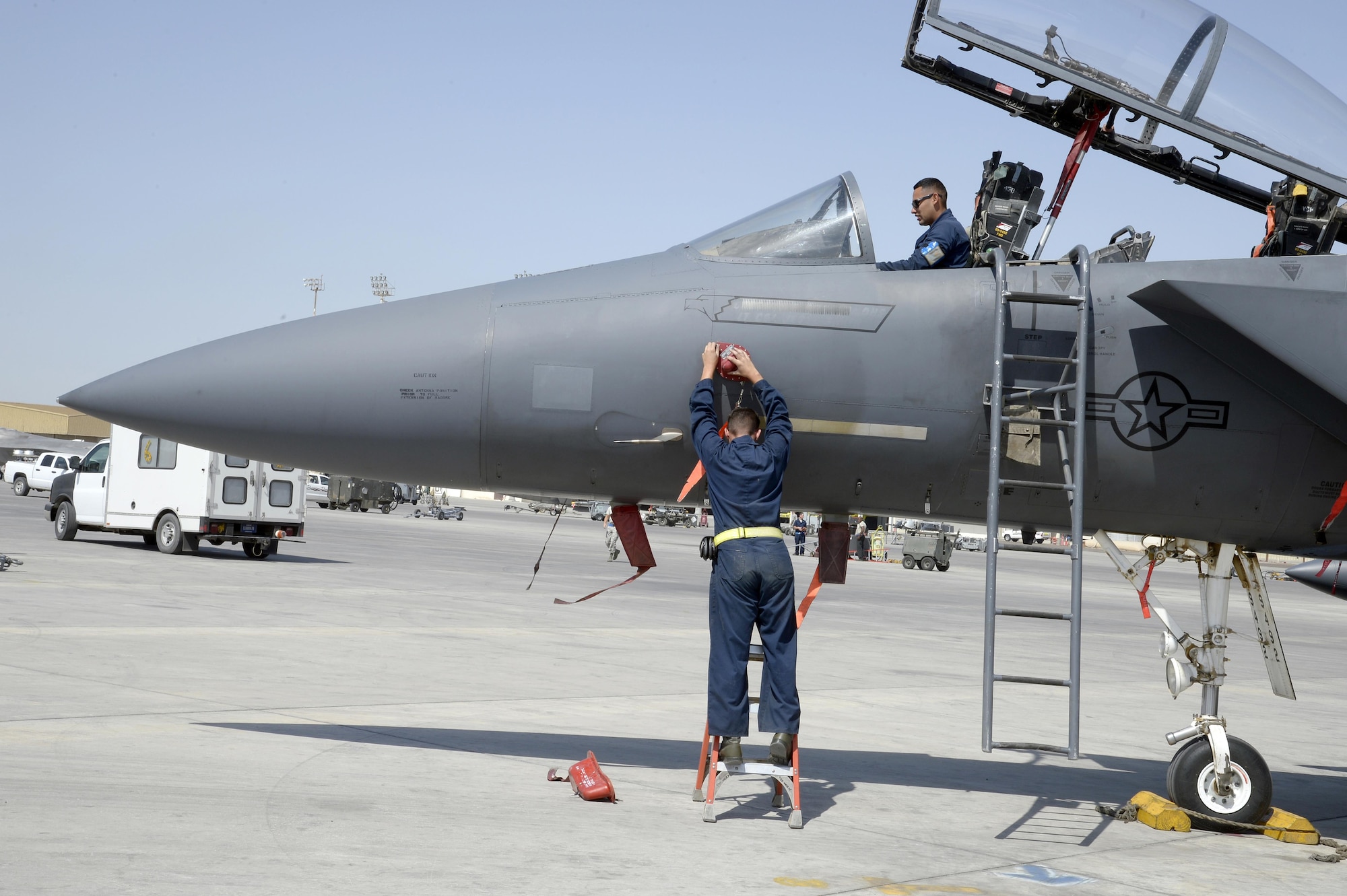 Staff Sgt Omar, top, and Staff Sgt. Jared, F-15E crew chiefs, are preparing the aircraft safe for maintenance during a post-flight inspection at an undisclosed location in Southwest Asia Feb. 25, 2015. The F-15E Strike Eagle is a dual-role fighter designed to perform air-to-air and air-to-ground missions. Both Airmen are currently deployed from Seymour Johnson Air Force Base, N.C. (U.S. Air Force photo/Tech. Sgt. Marie Brown)