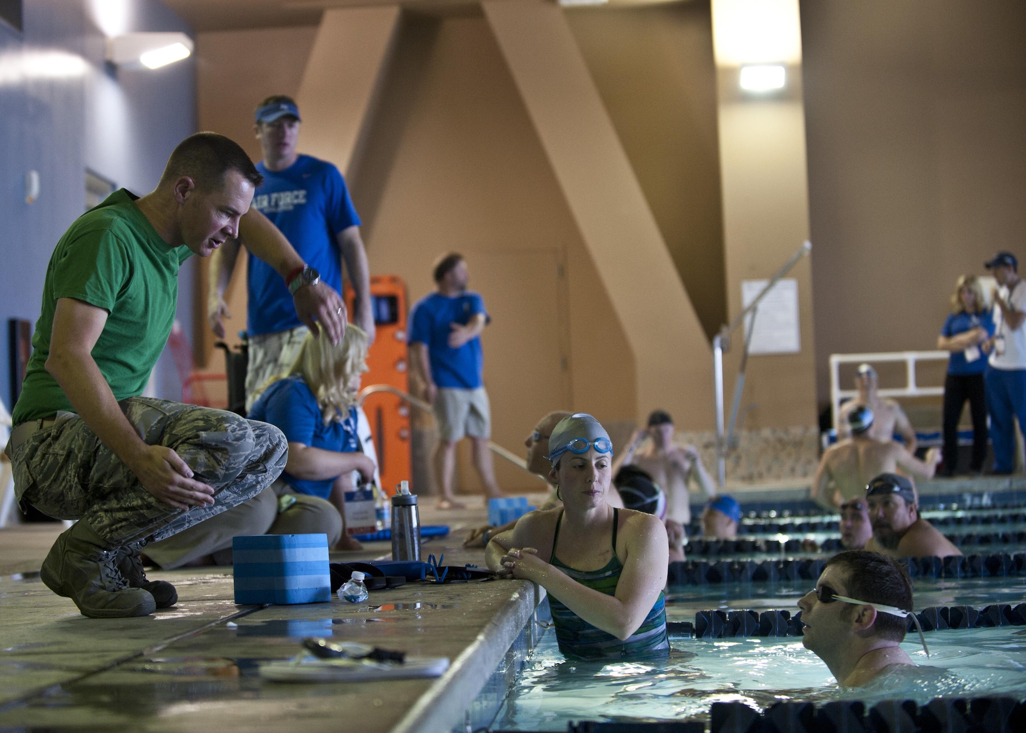 Maj. James Ross demonstrates proper arm motion Feb. 27, 2015, during a 2015 U.S. Air Force Trials swimming team practice session at Nellis Air Force Base, Nev. Ross and more than 200 members of Nellis and Creech AFBs volunteered to help out during the trials, which will run Feb. 27 to March 5. Ross is the 422nd Test and Evaluation Squadron air battle manager. (U.S. Air Force photo/Staff Sgt. Siuta B. Ika)