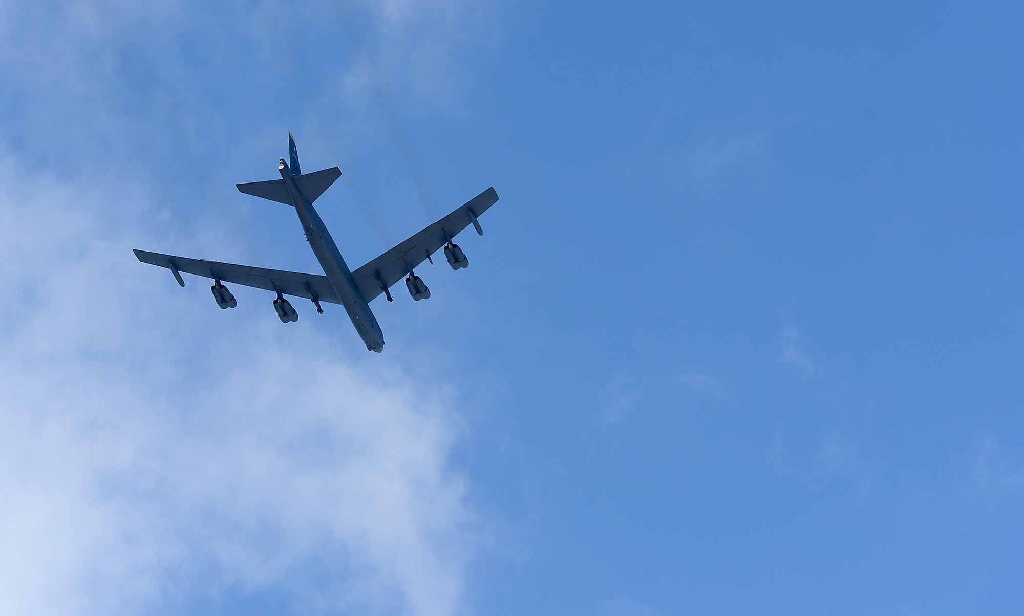 A B-52 Stratofortress flies over the Air Force Memorial during a wreath laying ceremony March 2, 2015, hosted by Air Force Chief of Staff Gen. Mark A. Welsh III, honoring Air Force Vietnam prisoners of war and missing in action in Arlington, Va. The B-52 is from the 69th Bomb Squadron at Minot Air Force Base, N.D. (U.S. Air Force photo/Scott M. Ash)