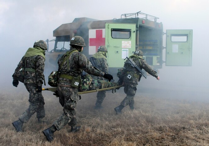 YONGSAN GARRISON, South Korea (Feb. 26, 2015) - South Korean medical soldiers carry a simulated American casualty during a training exercise with Soldiers from 65th Medical Brigade and other elements of the U.S. Eighth Army near Yangju. The purpose of the combined Korea-U.S. military exercise was to synchronize medical operations in the event of a mass casualty situation caused by chemical or biological munitions.  