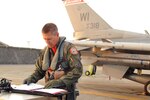 U.S. Air Force Lt. Col. Matthew C. McCunn, Wisconsin Air National Guard, 115th Fighter Wing pilot, prepares for his flight at Kadena Air Base, Japan, Feb. 13, 2015. McCunn reached a career total of 3,000 flying hours while deployed to Kadena during a joint training mission with the 18th Wing.