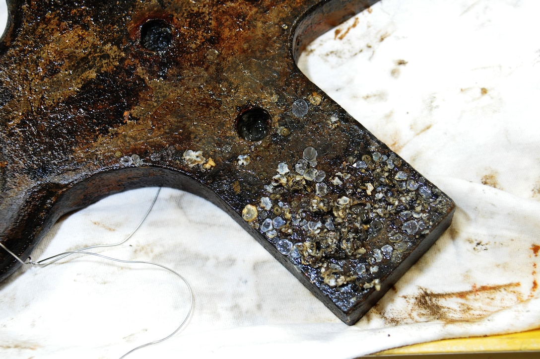 Even after 150 years underwater, this iron artifact from the CSS Georgia remained in relatively good condition. Divers recovered this item from among the wreckage of the Civil War ironclad. The item, initially a mystery to investigators, has been identified as “eyes for tackle” on the gun carriage holding a cannon on the ship. The item aided the ship’s crew to pull the cannon into firing position. (An accompanying illustration highlights the position of the item on the gun carriage.) The crew of the CSS Georgia scuttled the ship in 1864 as Union troops entered Savannah. The Corps of Engineers must remove the remains of the CSS Georgia from the bottom of the Savannah River in order to increase the depth of the shipping channel. Artifacts recovered from the Georgia will be shipped to Texas A&M University for further study and preservation under a contract awarded as part of the Savannah Harbor Expansion Project (SHEP). (U.S. Army Corps of Engineers photo by Billy Birdwell.)