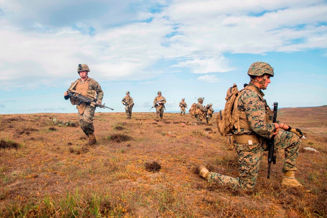 U.S. Marines with Battalion Landing Team 3rd Battalion, 1st Marine Regiment, 15th Marine Expeditionary Unit, move into position during a mechanized raid as part of Amphibious Squadron/Marine Expeditionary Unit Integration Training (PMINT) aboard San Clemente Island, Calif., March 1, 2015. During the training, Marines rehearsed ship-to-shore movements utilizing AAV-7 Amphibious Assault Vehicles. (U.S. Marine Corps photo by Sgt. Emmanuel Ramos/Released)