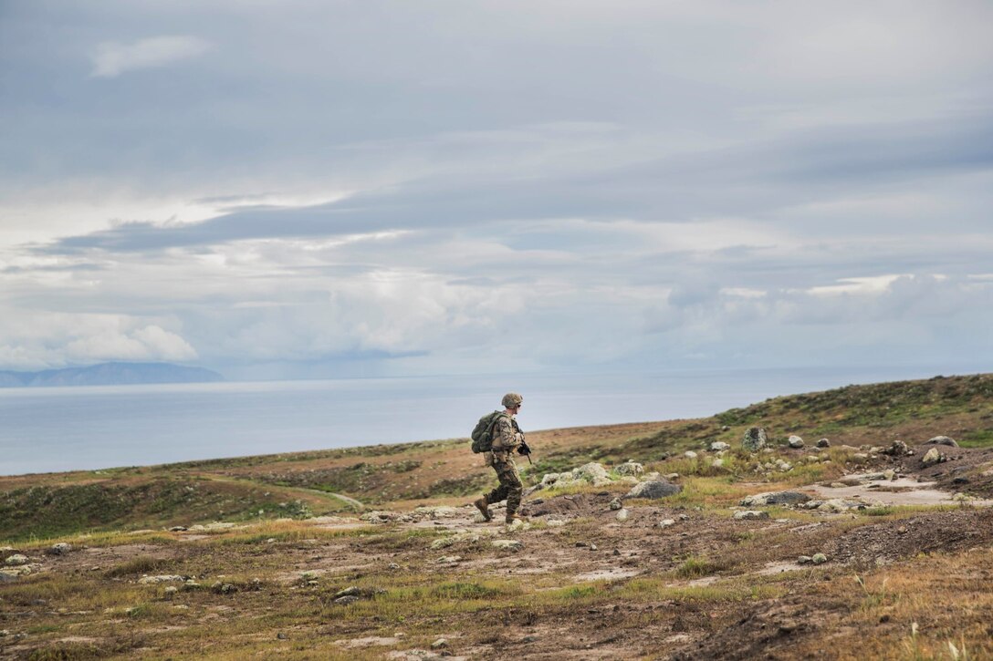A U.S. Marine with Battalion Landing Team 3rd Battalion, 1st Marine Regiment, 15th Marine Expeditionary Unit, patrols to an objective during a mechanized raid as part of Amphibious Squadron/Marine Expeditionary Unit Integration Training (PMINT) aboard San Clemente Island, Calif., March 1, 2015. During the training, Marines seized a simulated enemy stronghold after conducting an amphibious movement from the USS Rushmore (LSD-47 ). (U.S. Marine Corps photo by Sgt. Emmanuel Ramos/Released)