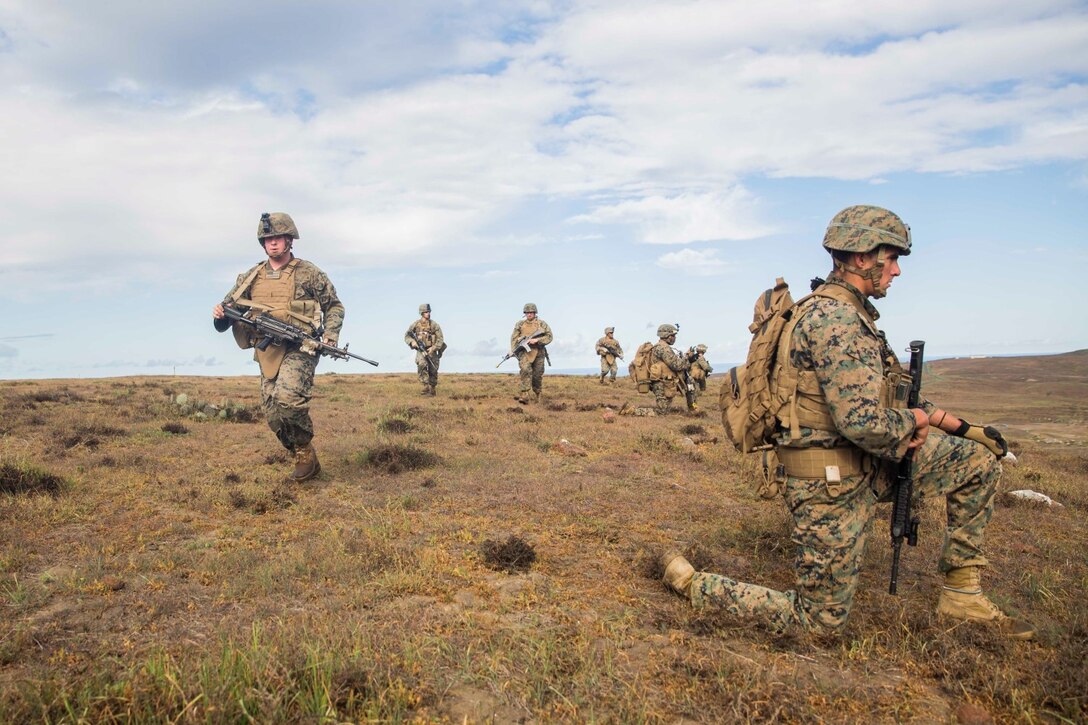 U.S. Marines with Battalion Landing Team 3rd Battalion, 1st Marine Regiment, 15th Marine Expeditionary Unit, move into position during a mechanized raid as part of Amphibious Squadron/Marine Expeditionary Unit Integration Training (PMINT) aboard San Clemente Island, Calif., March 1, 2015. During the training, Marines rehearsed ship-to-shore movements utilizing AAV-7 Amphibious Assault Vehicles. (U.S. Marine Corps photo by Sgt. Emmanuel Ramos/Released)