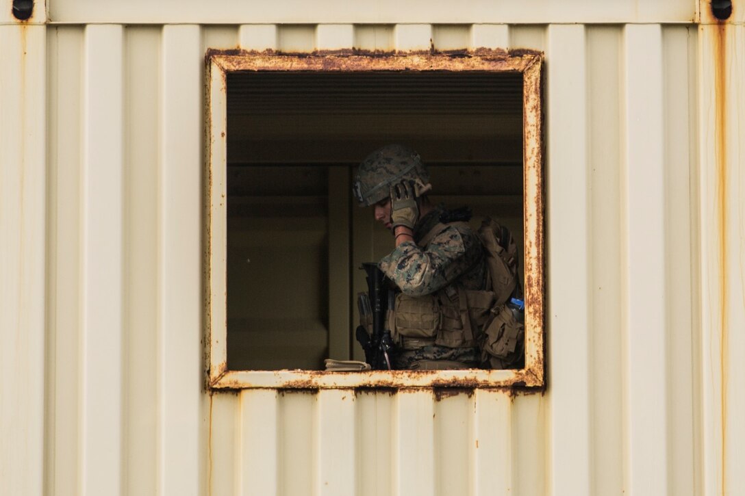 U.S. Marine Cpl. Michael Hicks gathers intelligence and documentation during a mechanized raid as part of Amphibious Squadron/Marine Expeditionary Unit Integration Training (PMINT) aboard San Clemente Island, Calif., March 1, 2015. Hicks is a military policeman attached to Kilo Company, Battalion Landing Team 3rd Battalion, 1st Marine Regiment, 15th Marine Expeditionary Unit. During the training, Marines learned to integrate with supporting elements such as military law enforcement, explosive ordnance disposal technicians, and intelligence analysts. (U.S. Marine Corps photo by Sgt. Emmanuel Ramos/Released)