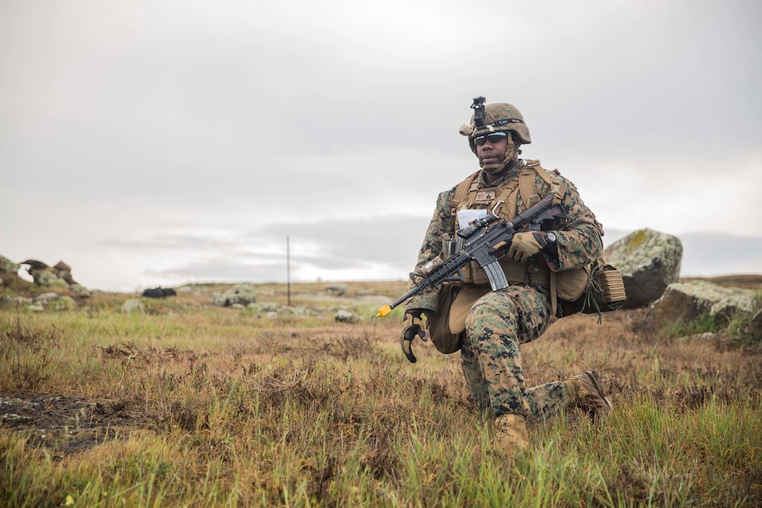 U.S. Marine Cpl. Heath Crouch sets up security before moving to his objective during a mechanized raid as part of Amphibious Squadron/Marine Expeditionary Unit Integration Training (PMINT) aboard San Clemente Island, Calif., March 1, 2015. Crouch is an intelligence analyst with Kilo Company, Battalion Landing Team 3rd Battalion, 1st Marine Regiment, 15th Marine Expeditionary Unit. The training allowed Marines and Sailors to integrate and prepare for complex operations like raids using AAV-7 Amphibious Assault Vehicles. (U.S. Marine Corps photo by Sgt. Emmanuel Ramos/Released)