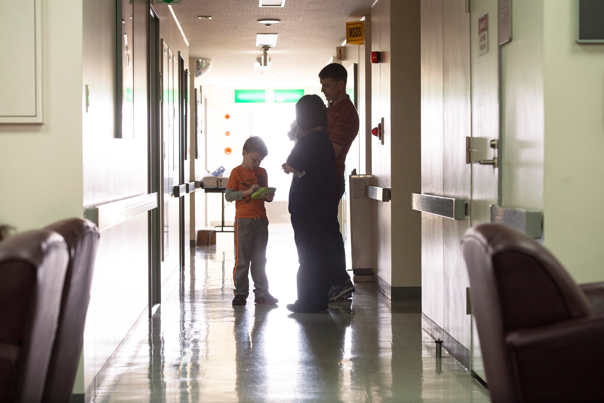 A father and son speak with a dentist at the Yokota Dental Clinic, Feb. 28, 2015, during the Little Teeth-Big Smiles event. By participating in dental health month, The 374th Dental Squadron worked to ensure that both parents and children understand the importance of proper hygiene. (U.S. Air Force photo by Airman 1st Class Delano Scott/Released) 