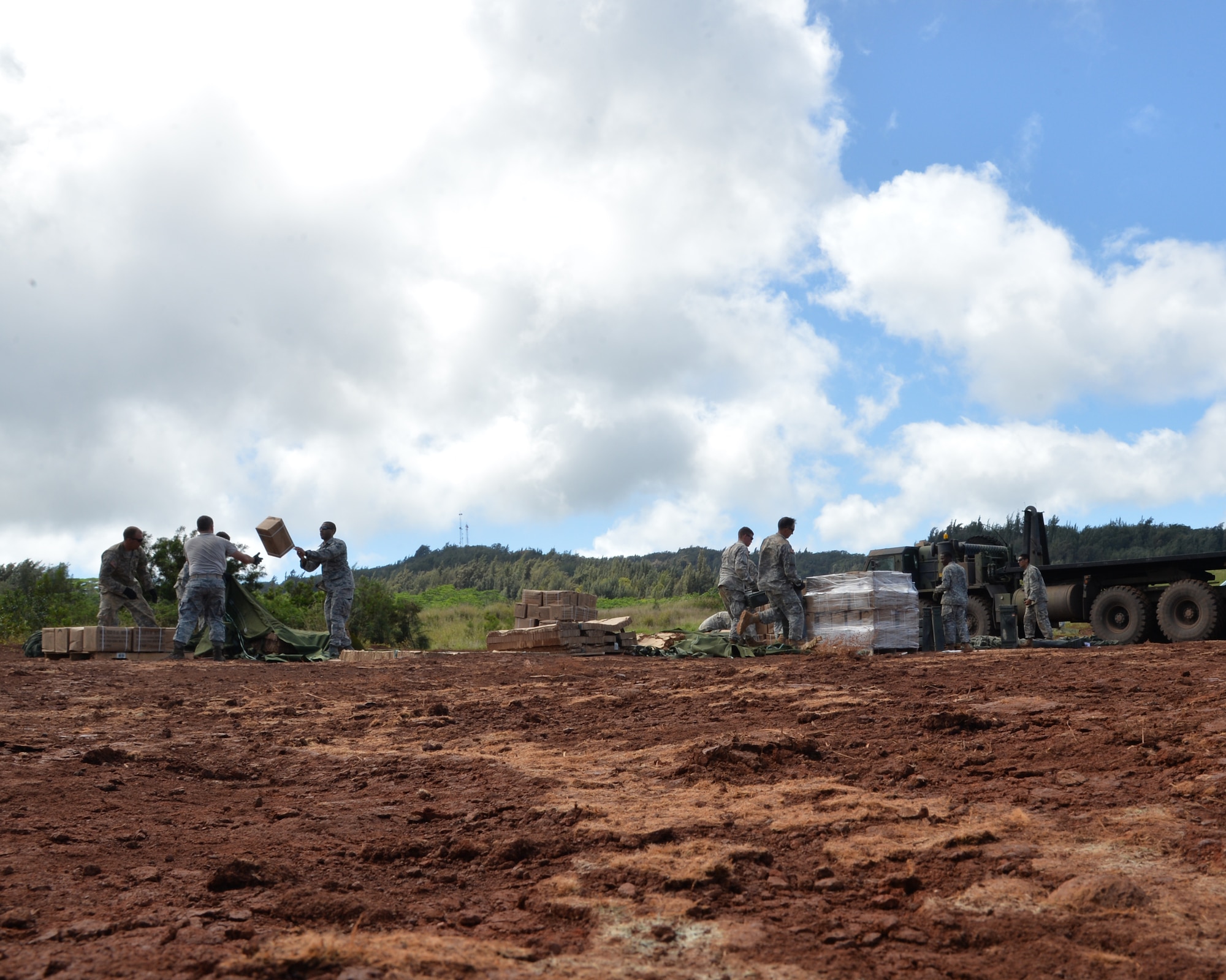Airmen from the 647th Logistics Readiness Squadron and Soldiers from the 25th Infantry Division recover supplies on Kahuku Training Area, Hawaii, March 2, 2015. The supplies were airdropped by two C-17 Globalmaster III, from the 15th Wing, Joint Base Pearl Harbor-Hickam, Hawaii, in support of the25th ID exercise Lightening Forge. Lightning Forge is a force-on-force scenario involving eight battalions from the 25th ID. (U.S. Air Force photo by Tech. Sgt. Aaron Oelrich/Released)
