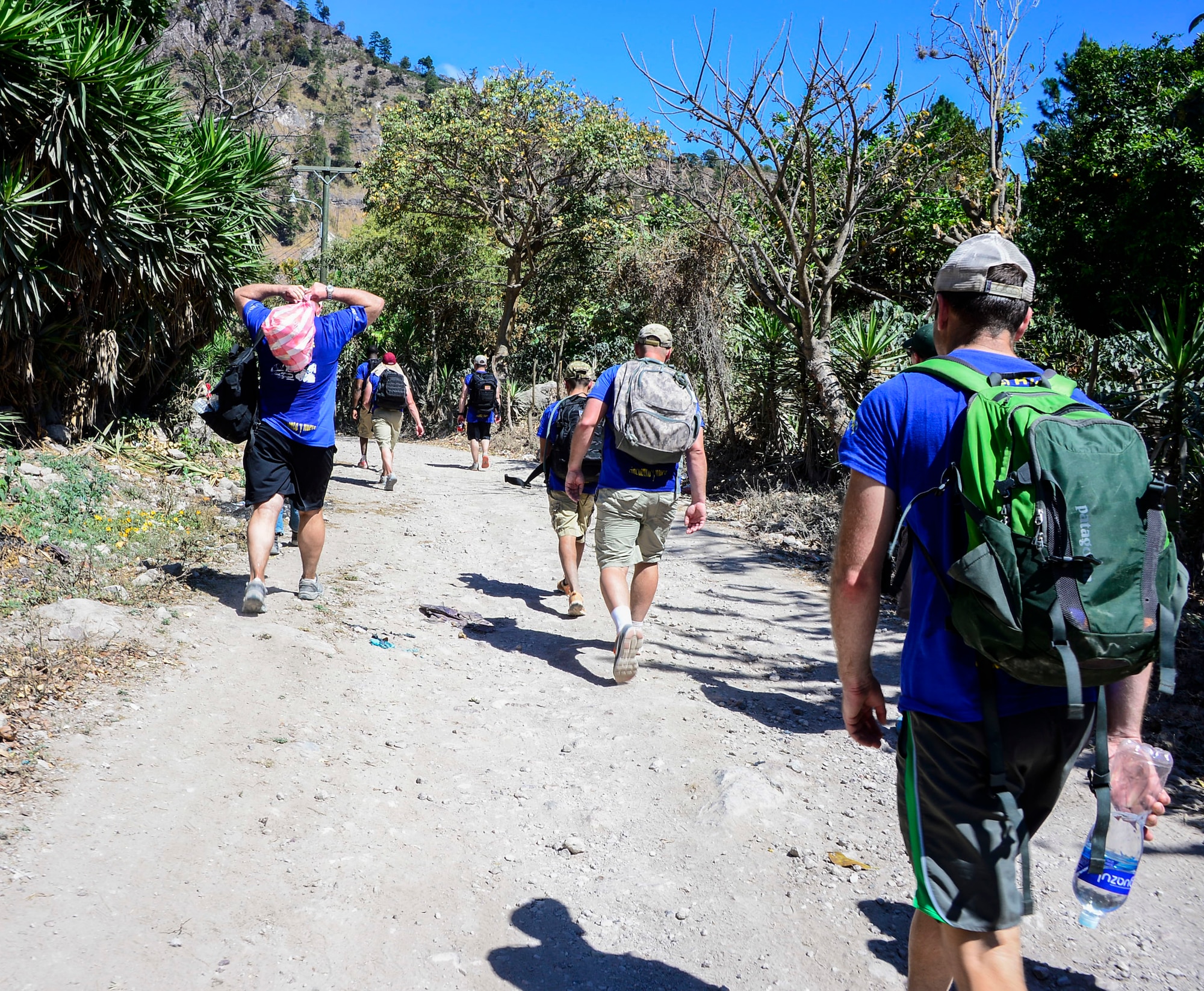 Joint Task Force-Bravo volunteers carry more than 20-pounds of food in backpacks to villagers in La Brea and Laguna, Honduras, Feb. 28, 2015.   As part of the 59th Chapel Hike, more than 172 members assigned to Joint Task Force-Bravo laced up their hiking boots and completed a seven-mile round trip hike to deliver over 4,500-pounds of donated try goods to villagers in need.( U.S. Air Force photo/Tech. Sgt. Heather Redman)
