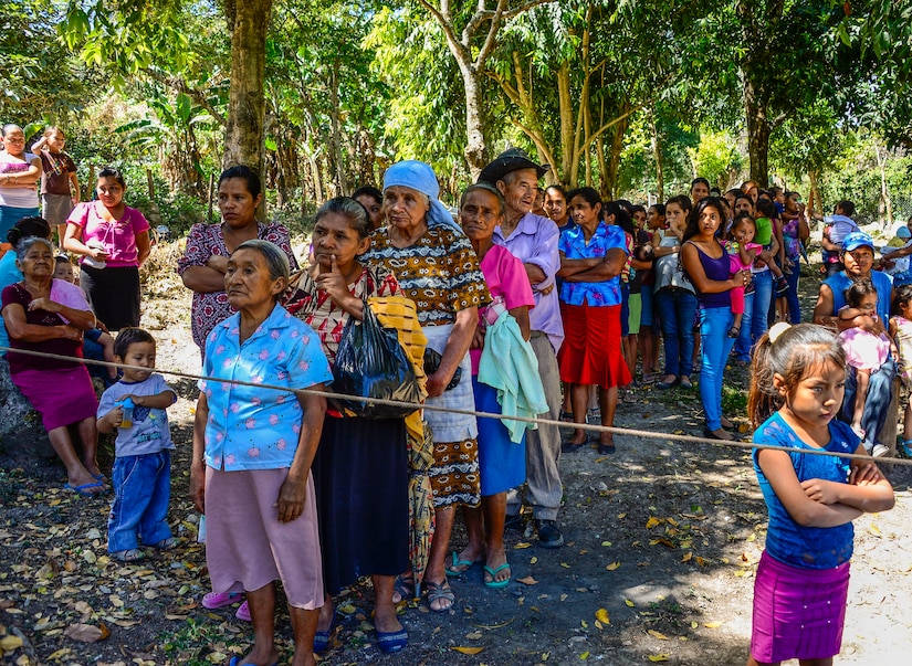 Villagers from Laguna, Honduras, line up to receive bags of goods from members of Joint Task Force-Bravo, Feb. 28, 2015.   As part of the 59th Chapel Hike, more than 172 members assigned to Joint Task Force-Bravo laced up their hiking boots and completed a seven-mile round trip hike to deliver over 4,500-pounds of donated try goods to villagers in need. (U.S. Air Force photo/Tech. Sgt. Heather Redman)
