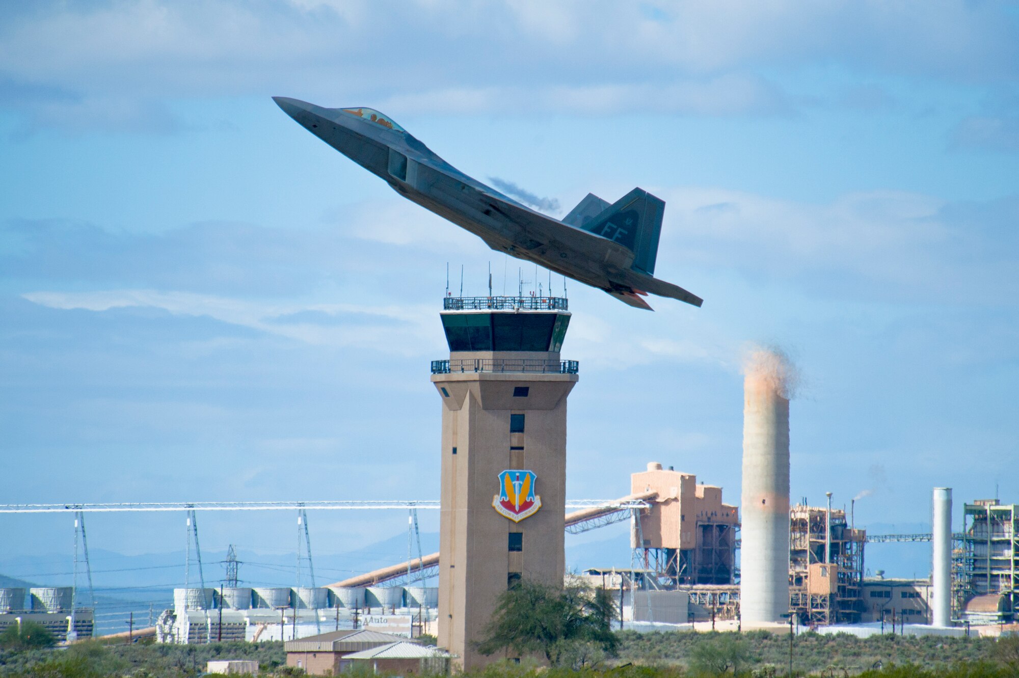 An F-22 Raptor takes off from the runway during the 2015 Heritage Flight Training and Certification Course at Davis-Monthan Air Force Base, Ariz., March 1, 2015.  During the course, aircrews practiced ground and flight training to enable civilian pilots of historic military aircraft and U.S. Air Force pilots of current fighter aircraft to fly safely in formations together. (U.S. Air Force photo by Airman 1st Class Chris Massey/Released)