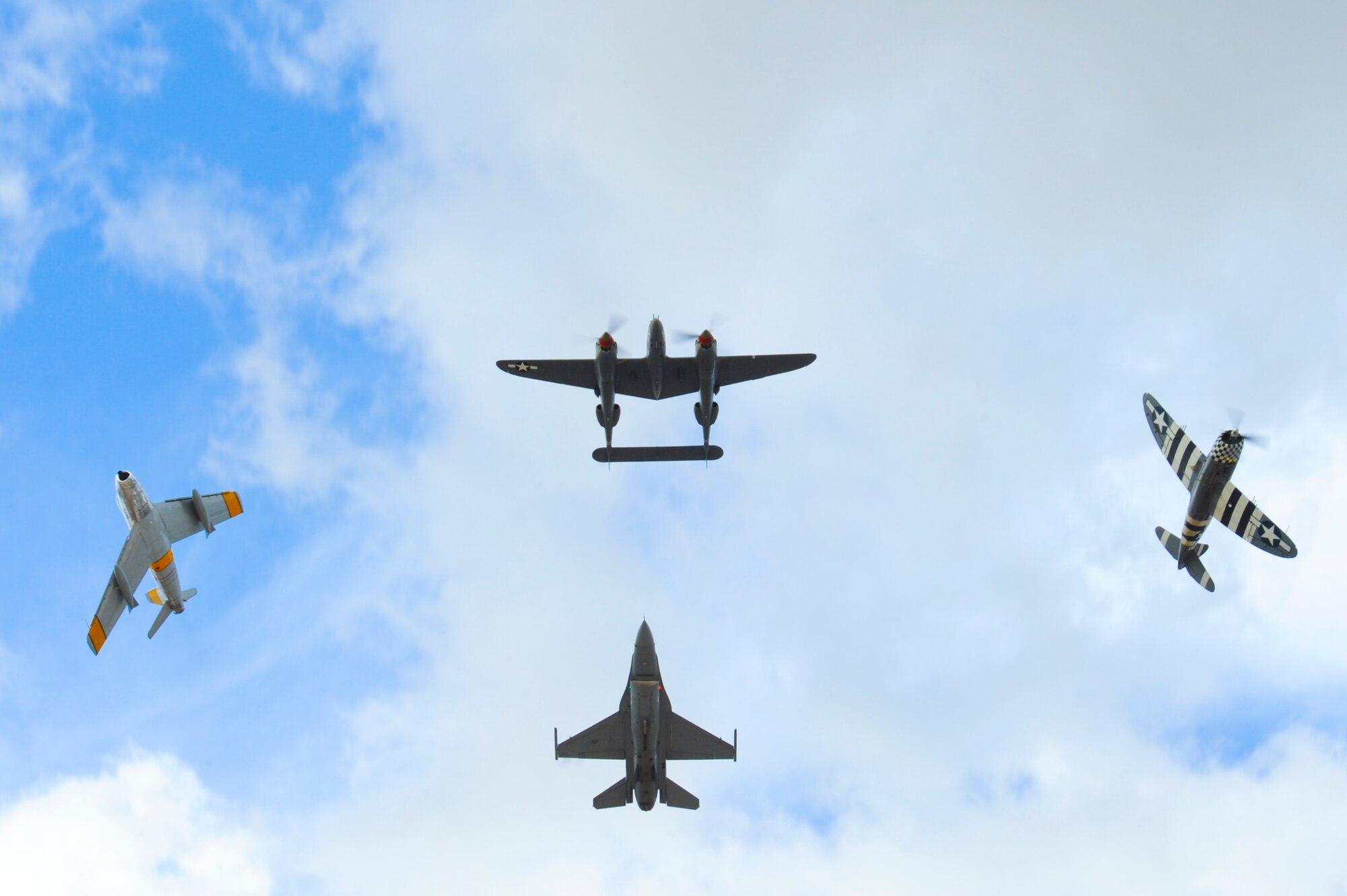 An F-86 Sabre, P-38 Lightning, F-16 Fighting Falcon and P-51 Mustang fly in formation during the 2015 Heritage Flight Training and Certification Course at Davis-Monthan Air Force Base, Ariz., Feb. 28, 2015.  Established in 1997, the HFTCC featured aerial demonstrations from historical and modern fighter aircraft which will fly in formation together during air shows across the country. (U.S. Air Force photo by Airman 1st Class Chris Massey/Released)