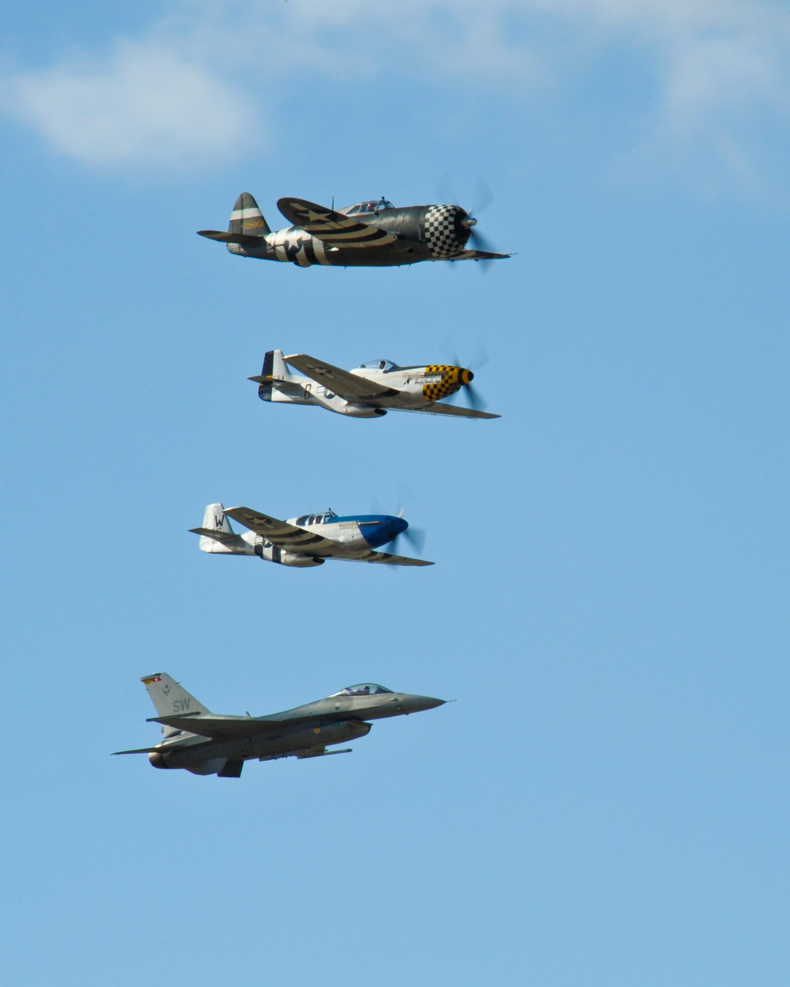 A P-47 Thunderbolt, two P-51 Mustangs and F-16 Fighting Falcon fly in formation during the 2015 Heritage Flight Training and Certification Course at Davis-Monthan Air Force Base, Ariz., Feb. 28, 2015.  The annual aerial demonstration training event has been held at D-M since 2001, providing civilian and military pilots the opportunity to practice flying in formation for the upcoming air show season. (U.S. Air Force photo by Airman 1st Class Chris Massey/Released)