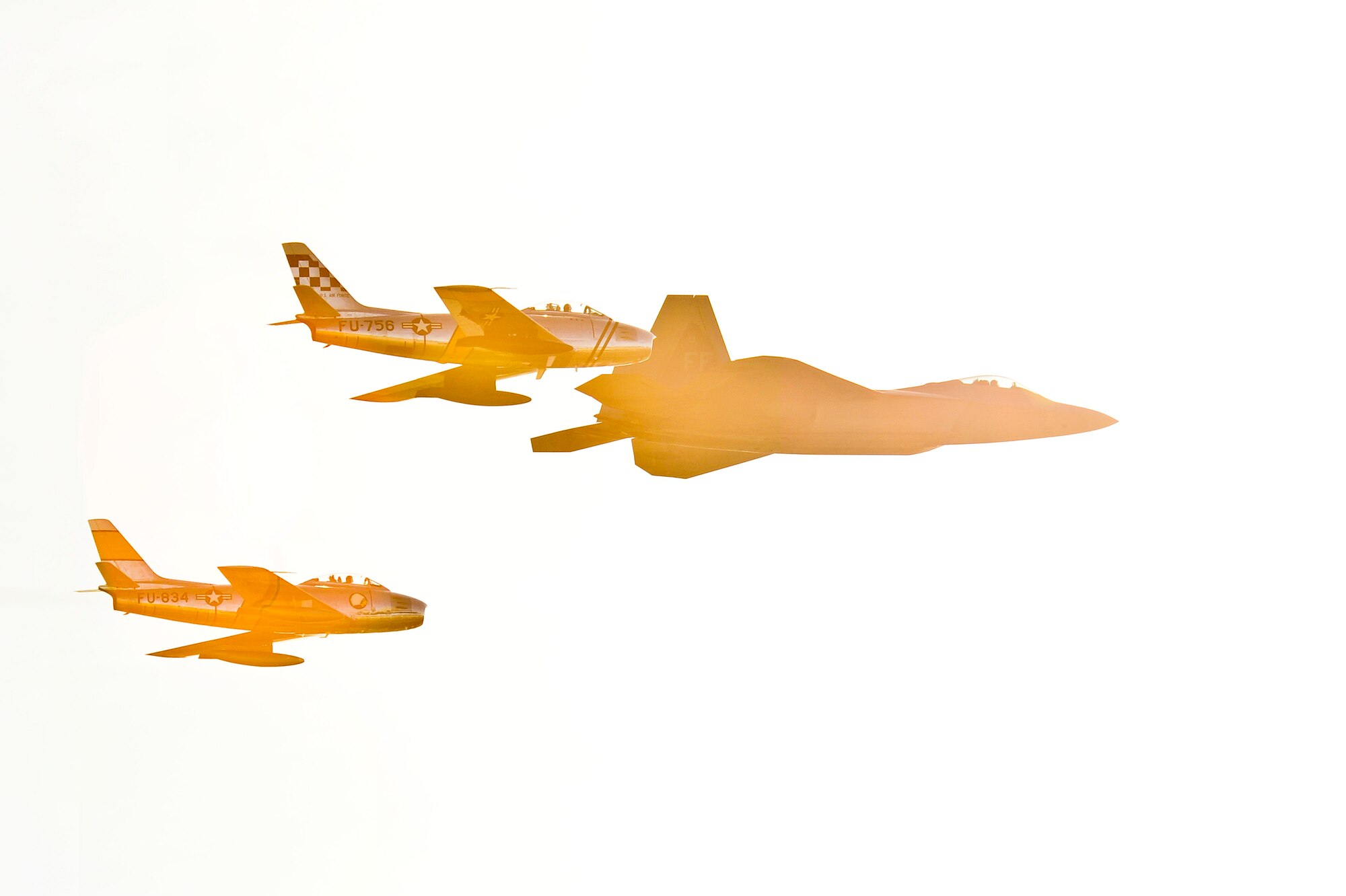 Two F-86 Sabres and an F-22 Raptor fly in formation during the 2015 Heritage Flight Training and Certification Course at Davis-Monthan Air Force Base, Ariz., Feb. 27, 2015.  Established in 1997, the HFTCC featured aerial demonstrations from historical and modern fighter aircraft which will fly in formation together during air shows across the country. (U.S. Air Force photo by Airman 1st Class Chris Massey/Released)