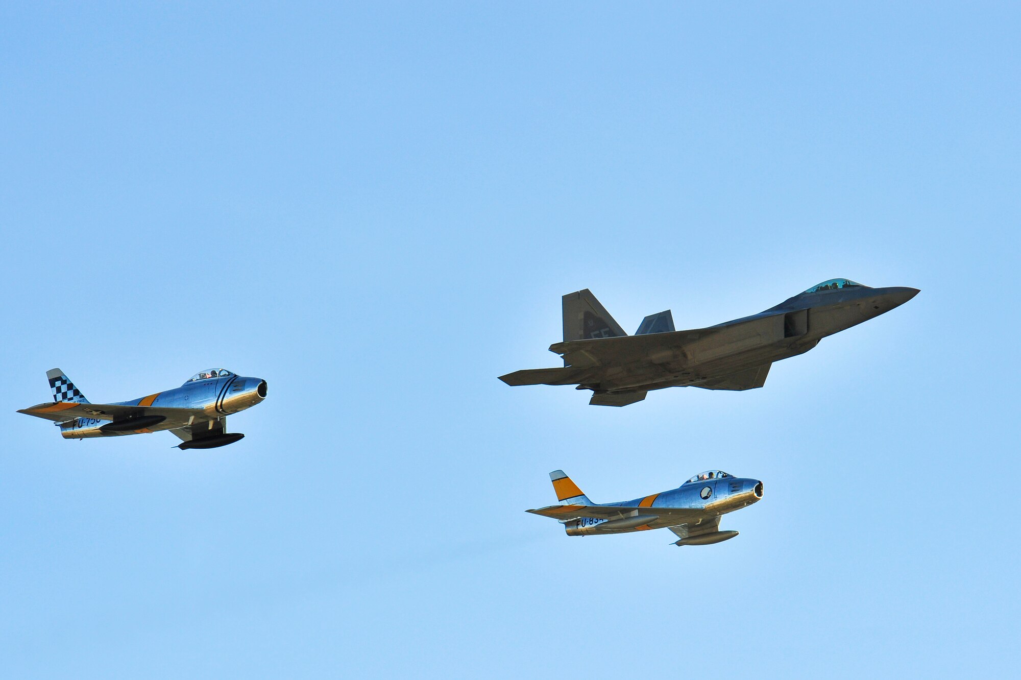 Two F-86 Sabres and an F-22 Raptor fly in formation during the 2015 Heritage Flight Training and Certification Course at Davis-Monthan Air Force Base, Ariz., Feb. 27, 2015. Established in 1997, the HFTCC featured aerial demonstrations from historical and modern fighter aircraft which will fly in formation together during air shows across the country. (U.S. Air Force photo by Airman 1st Class Chris Massey/Released)