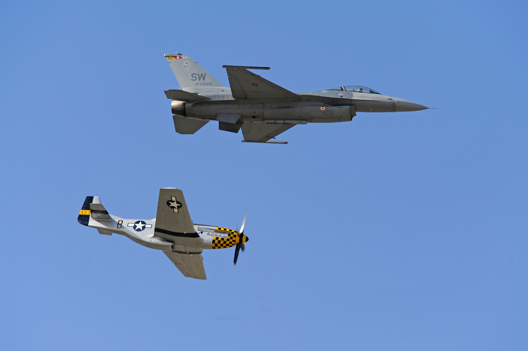 A P-51 Mustang and an F-16 Fighting Falcon practice flying their aerial demonstration during the 2015 Heritage Flight Training and Certification Course at Davis-Monthan Air Force Base, Ariz., Feb. 28, 2015. Established in 1997, the HFTCC featured aerial demonstrations from historical and modern fighter aircraft which will fly in formation together during air shows across the country. (U.S. Air Force photo by Airman 1st Class Betty R. Chevalier)