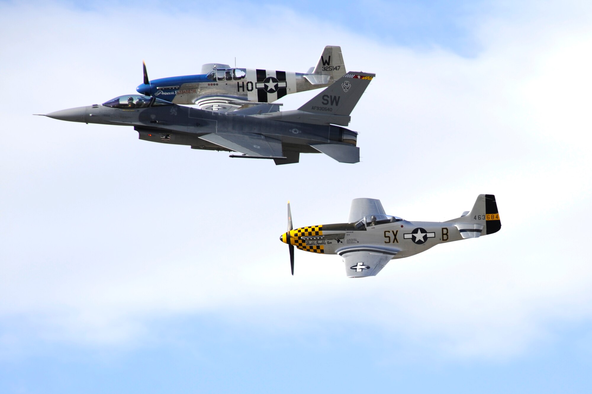 An F-16 Fighting Falcon and two P-51 Mustangs fly in formation together during the 2015 Heritage Flight Training and Certification Course at Davis-Monthan Air Force Base, Ariz., Feb. 28, 2015. The annual aerial demonstration training event has been held at D-M since 2001, providing civilian and military pilots the opportunity to practice flying in formation in for the upcoming air show season. (U.S. Air Force photo by Airman 1st Class Betty R. Chevalier)