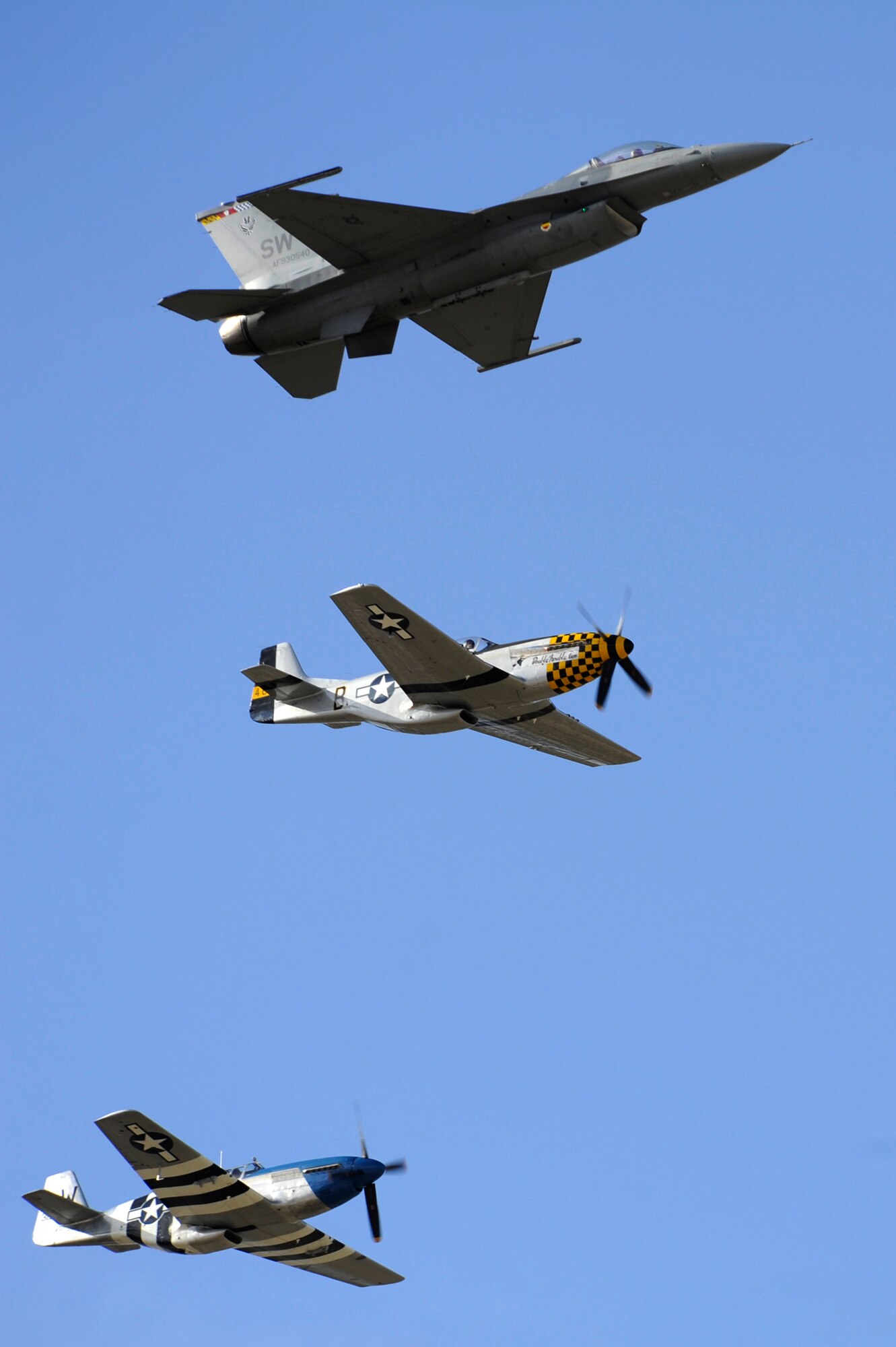 An F-16 Fighting Falcon and two P-51 Mustangs fly in formation together during the 2015 Heritage Flight Training and Certification Course at Davis-Monthan Air Force Base, Ariz., Feb. 28, 2015. The annual aerial demonstration training event has been held at D-M since 2001, providing civilian and military pilots the opportunity to practice flying in formation in for the upcoming air show season. (U.S. Air Force photo by Airman 1st Class Betty R. Chevalier)