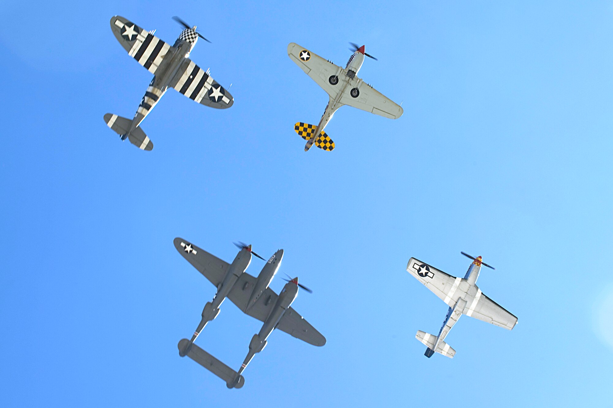 A P-47 Thunderbolt, P-40 Warhawk, P-38 Lightning and P-51 Mustang fly in formation during the 2015 Heritage Flight Training and Certification Course at Davis-Monthan Air Force Base Ariz., March 1, 2015. The annual aerial demonstration training event has been held at D-M since 2001, providing civilian and military pilots the opportunity to practice flying in formation together for the upcoming air show season. (U.S. Air Force photo by Airman 1st Class Chris Drzazgowski/Released)