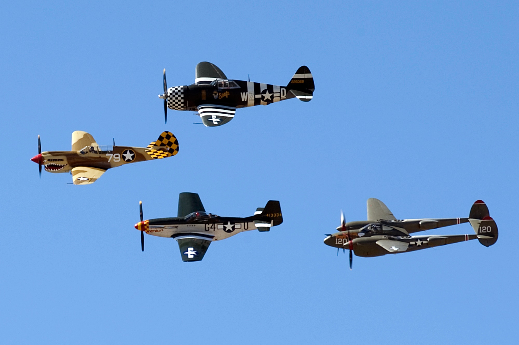 A P-40 Warhawk, P-51 Mustang, P-47 Thunderbolt and P-38 Lightning fly in formation during the 2015 Heritage Flight Training and Certification Course at Davis-Monthan Air Force Base Ariz., March 1, 2015. Established in 1997, the HFTCC featured aerial demonstrations from historical and modern fighter aircraft which will fly in formation together during air shows across the country. (U.S. Air Force photo by Airman 1st Class Chris Drzazgowski/Released)