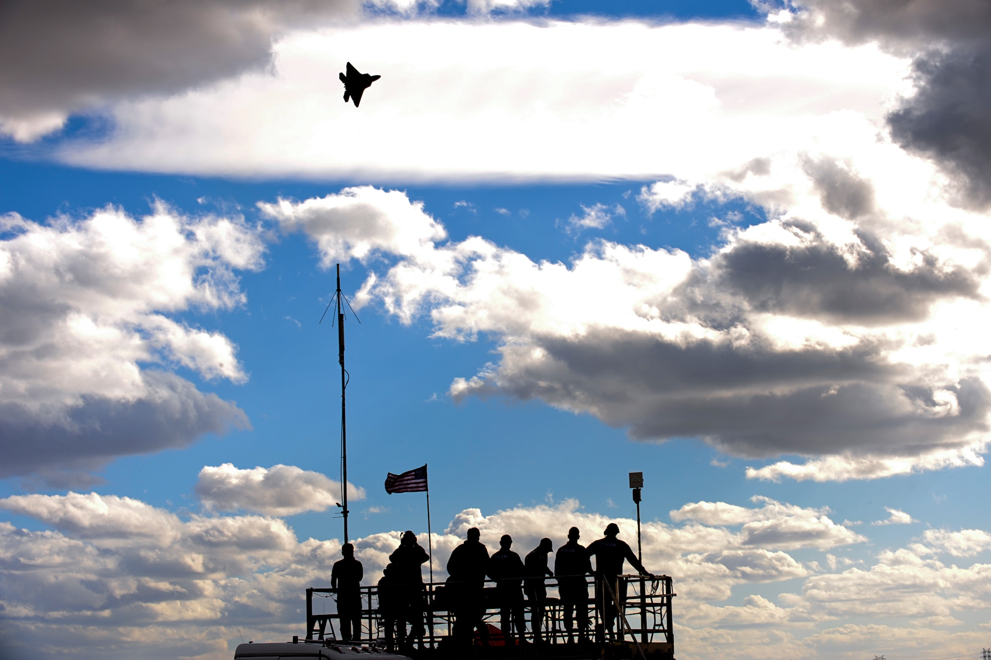 A U.S. Air Force F-22 Raptor flies above spectators during the 2015 Heritage Flight Training and Certification Course at Davis-Monthan Air Force Base, Ariz., Feb. 28, 2015. The annual aerial demonstration training event has been held at D-M since 2001, providing civilian and military pilots the opportunity to practice flying in formation together for the upcoming air show season. (U.S. Air Force photo by Airman 1st Class Chris Drzazgowski/Released) 