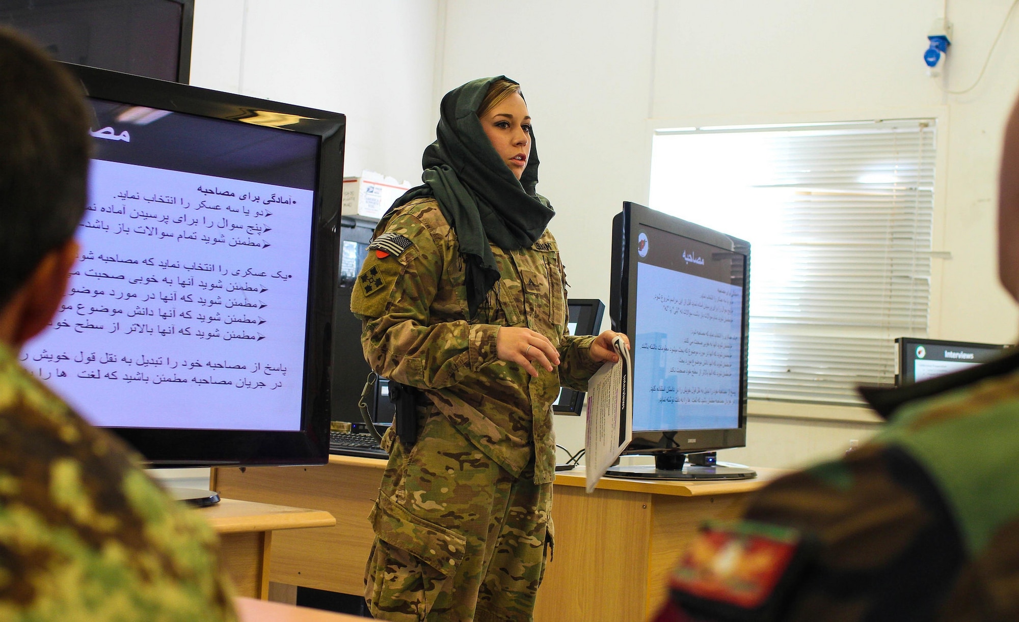 Sgt. Mariah Best of the 70th Mobile Public Affairs Detachment took third-place honors in the Outstanding News Articles category for her article covering International Women’s Day in Kandahar, Afghanistan. In this photo, Best teaches a public affairs workshop, instructing the Afghan soldiers how to write a print news article during the deployment. (U.S. Army National Guard photo by Sgt. Clay Beyersdorfer) 