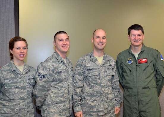 Citizen Airmen of the 131st Bomb Wing Public Affairs team were recognized recently for their first-place wins in the 2014 Air National Guard Media Contest. Col. Michael J. Francis, 131st Bomb Wing commander, presented his commander's coin to the following members: Staff Sergeant Elise Rich, Outstanding New Broadcaster, Senior Airman Nathan Dampf, Air Force Military Print Journalist of the Year, Air Force Military Print Journalist of the Year, Capt. Jeffrey Bishop, for his commentary, “Feedback: the Perfect Gift.” (U.S. Air National Guard photo by Tech. Sgt. Traci Payne) 
