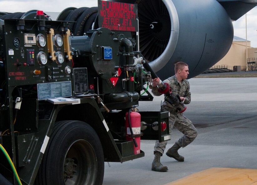 Airman 1st Class Daniel Langer, 92nd Logistics Readiness Squadron fuels distribution operator, stretches a fuel hose from an R-12 fuel truck in support of a KC-135 Stratotanker aircraft refueling operation March 2, 2015, at Fairchild Air Force Base, Wash. The Petroleum, Oil and Lubricants career field has a motto that sums up their role in the Air Force mission – “Without POL, pilots are pedestrians.” (U.S. Air Force photo/Capt. David Liapis)