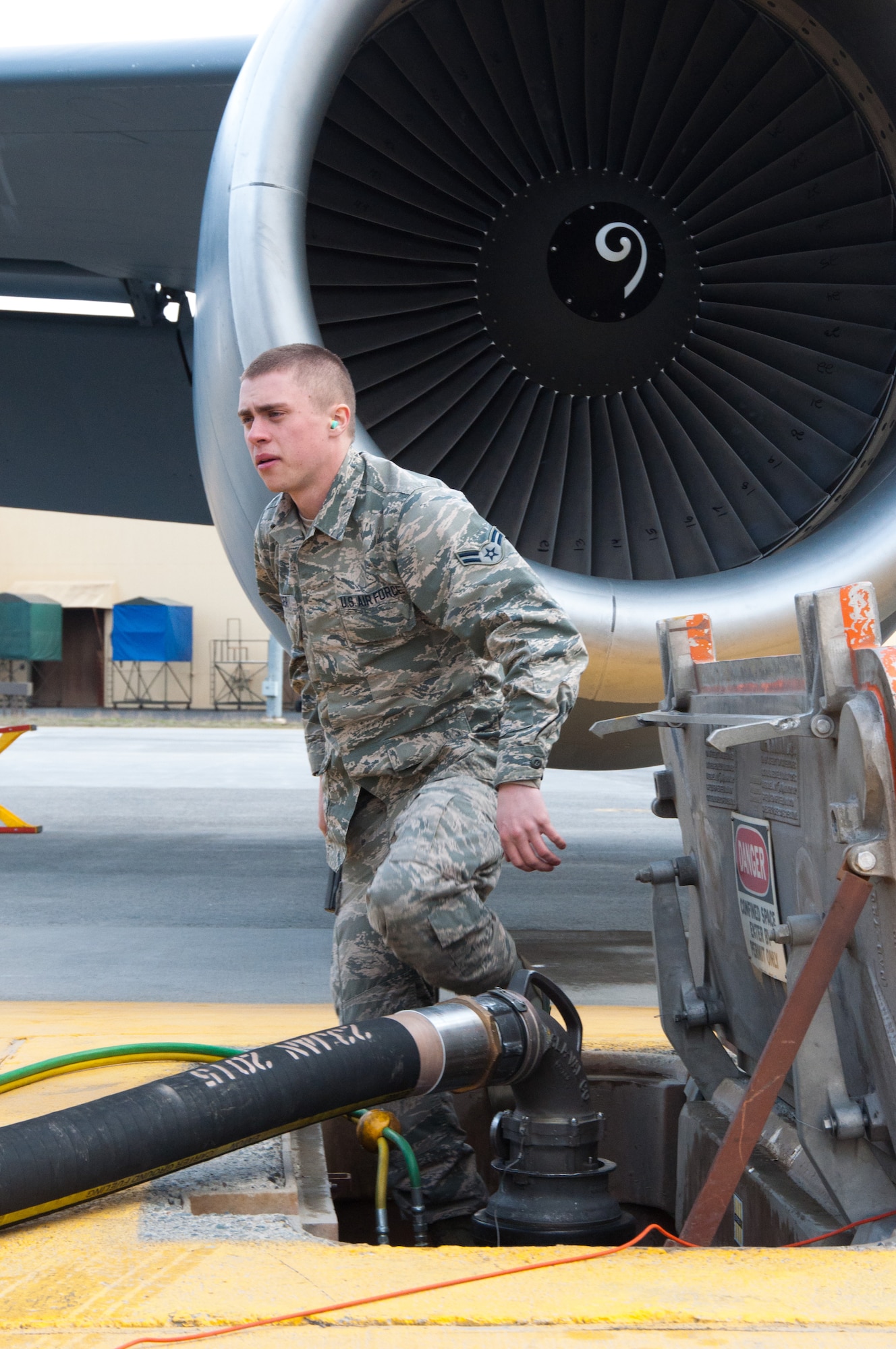 Airman 1st Class Daniel Langer, a 92nd Logistics Readiness Squadron fuels distribution operator, exits a fuel hydrant pit before pumping fuel from an R-12 fuel truck into a KC-135 Stratotanker aerial refueling aircraft assigned to the 92nd Air Refueling Wing March 2, 2015, at Fairchild Air Force Base, Wash. Langer and his fellow fuels distribution operators work around the clock in all weather conditions to ensure Fairchild’s KC-135s are ready to provide tanker support to a variety of missions that includes search & rescue, homeland defense, training and deployed operations. (U.S. Air Force photo/Capt. David Liapis)