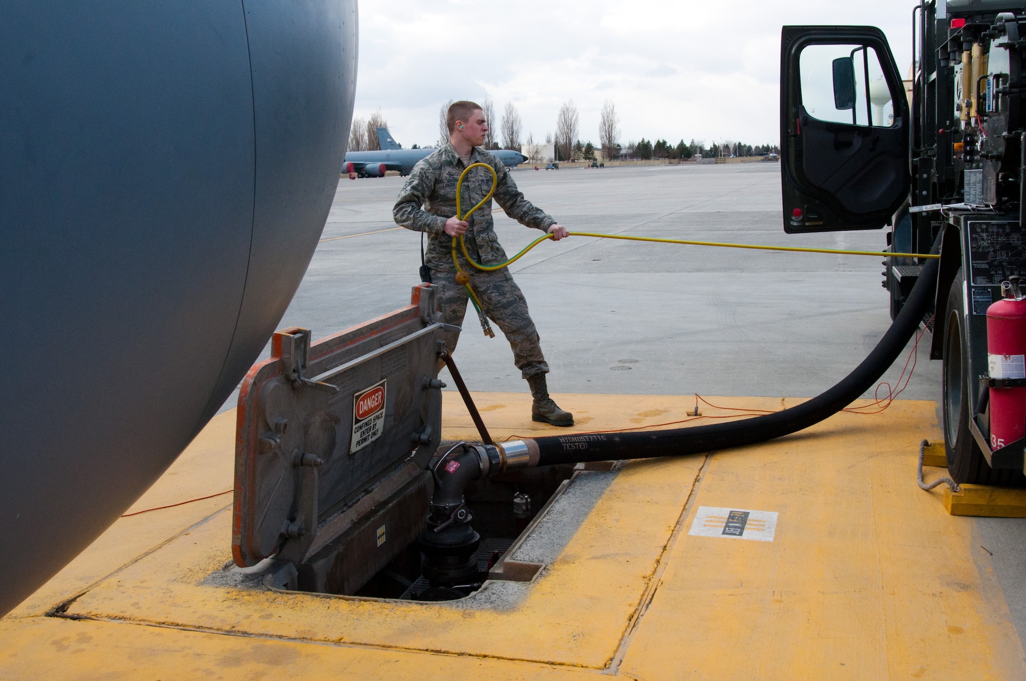 Airman 1st Class Daniel Langer, a 92nd Logistics Readiness Squadron fuels distribution operator, pulls fuel flow sensing lines from an R-12 Fuel Truck in preparation of a KC-135 Stratotanker aircraft refueling operation March 2, 2015, at Fairchild Air Force Base, Wash. Fuels distribution operators work in the Petroleum, Oil and Lubricants flight responsible for filling KC-135 Stratotankers with fuel both for aircraft use and refueling other planes from all branches of the U.S. military as well as some from allied nations. (U.S. Air Force photo/Capt. David Liapis)