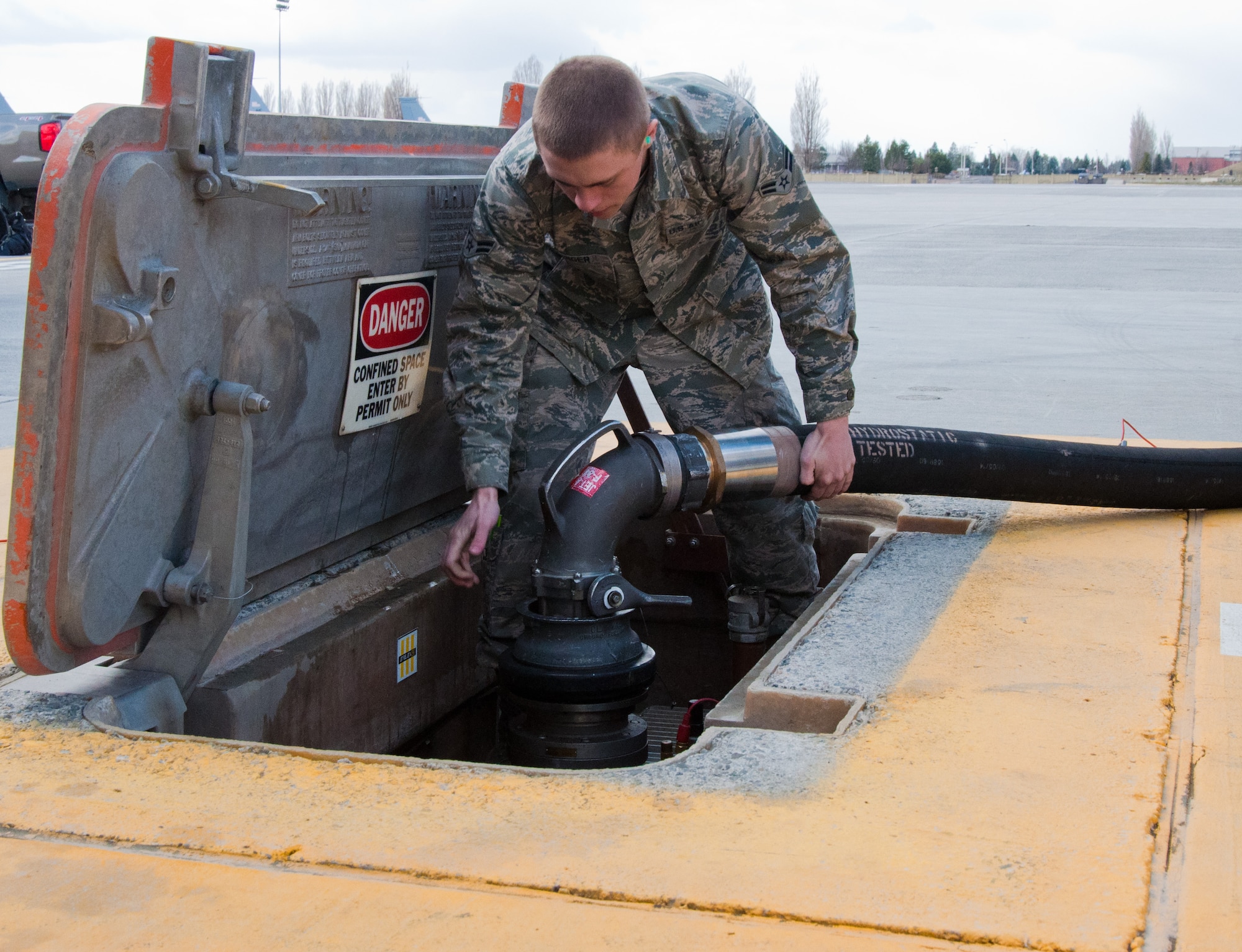 Airman 1st Class Daniel Langer, a 92nd Logistics Readiness Squadron fuels distribution operator, hooks up a “moose head” hydrant coupler from an R-12 fuel truck to the ground fuel hydrant system prior to an aircraft refueling operation March 2, 2015, at Fairchild Air Force Base, Wash. Fuels distribution operators use the R-12 fuel truck to connect aircraft to the ground-based fuel hydrant outlets. (U.S. Air Force photo/Capt. David Liapis)