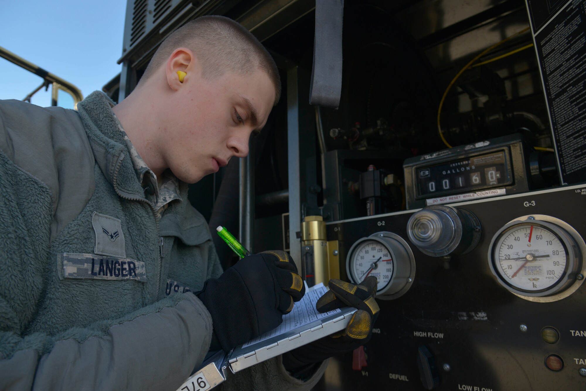 Airman 1st Class Daniel Langer, a 92nd Logistics Readiness Squadron fuels distribution operator, documents the fuel being pumped from an R-11 Fuel Truck to an aircraft Feb. 23, 2015, at Fairchild Air Force Base, Wash. The R-11 trucks hold a maximum of 6,000 gallons of fuel and are capable of dispensing the fuel at a rate of 600 gallons per minute. (U.S. Air Force photo/Senior Airman Janelle Patiño)