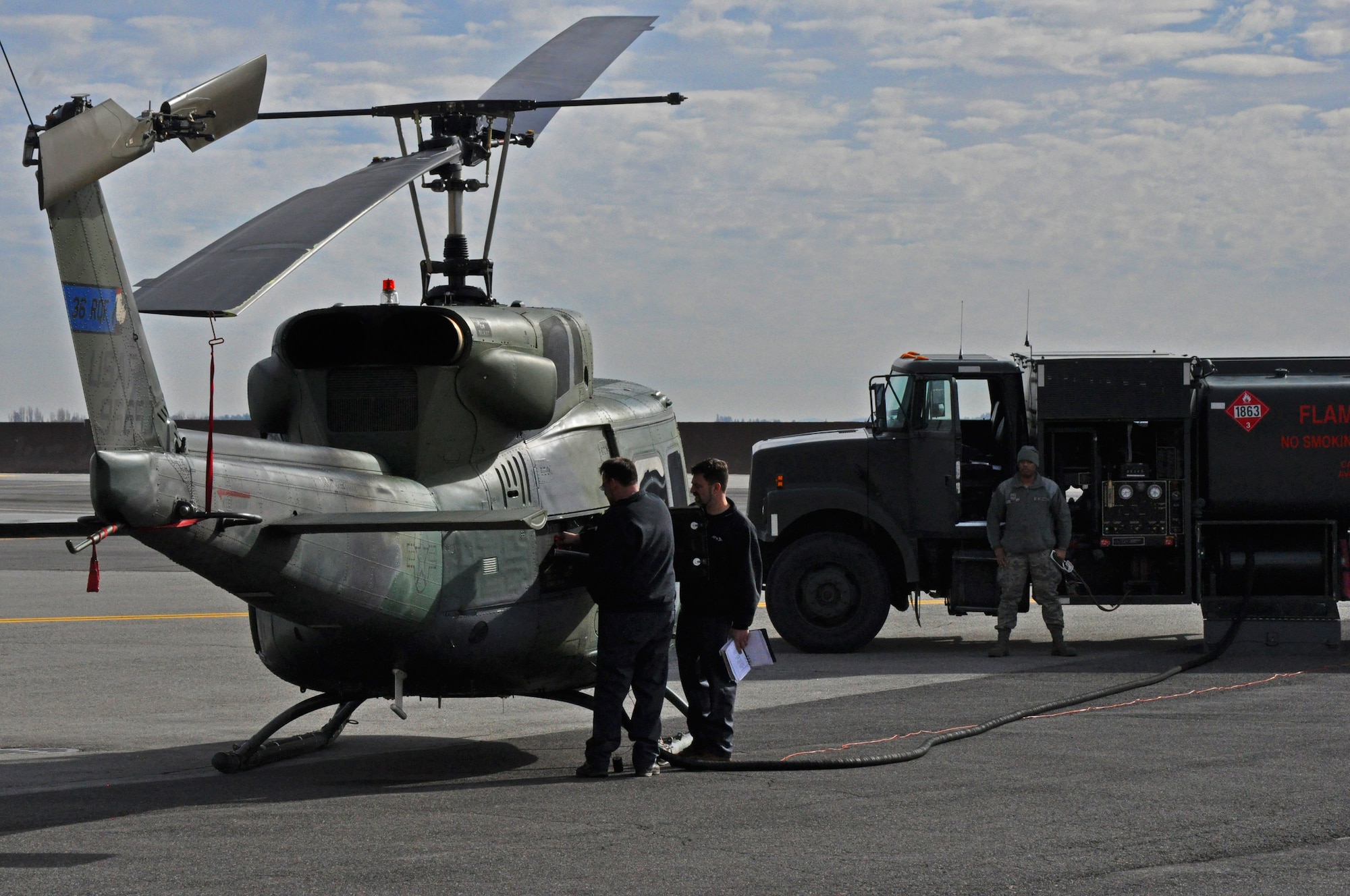 A 36th Rescue Squadron UH-1N Iroquois helicopter receives fuel from an R-11 fuel truck operated by the 92nd Logistics Readiness Squadron petroleum, oil and lubricants flight Feb. 18, 2015, at Fairchild Air Force Base, Wash. The fuel provided by the POL flight powers the 36 RQS aircraft that have aided in the 688 rescues credited to the squadron since its inception in 1971. (U.S. Air Force photo/Capt. David Liapis)