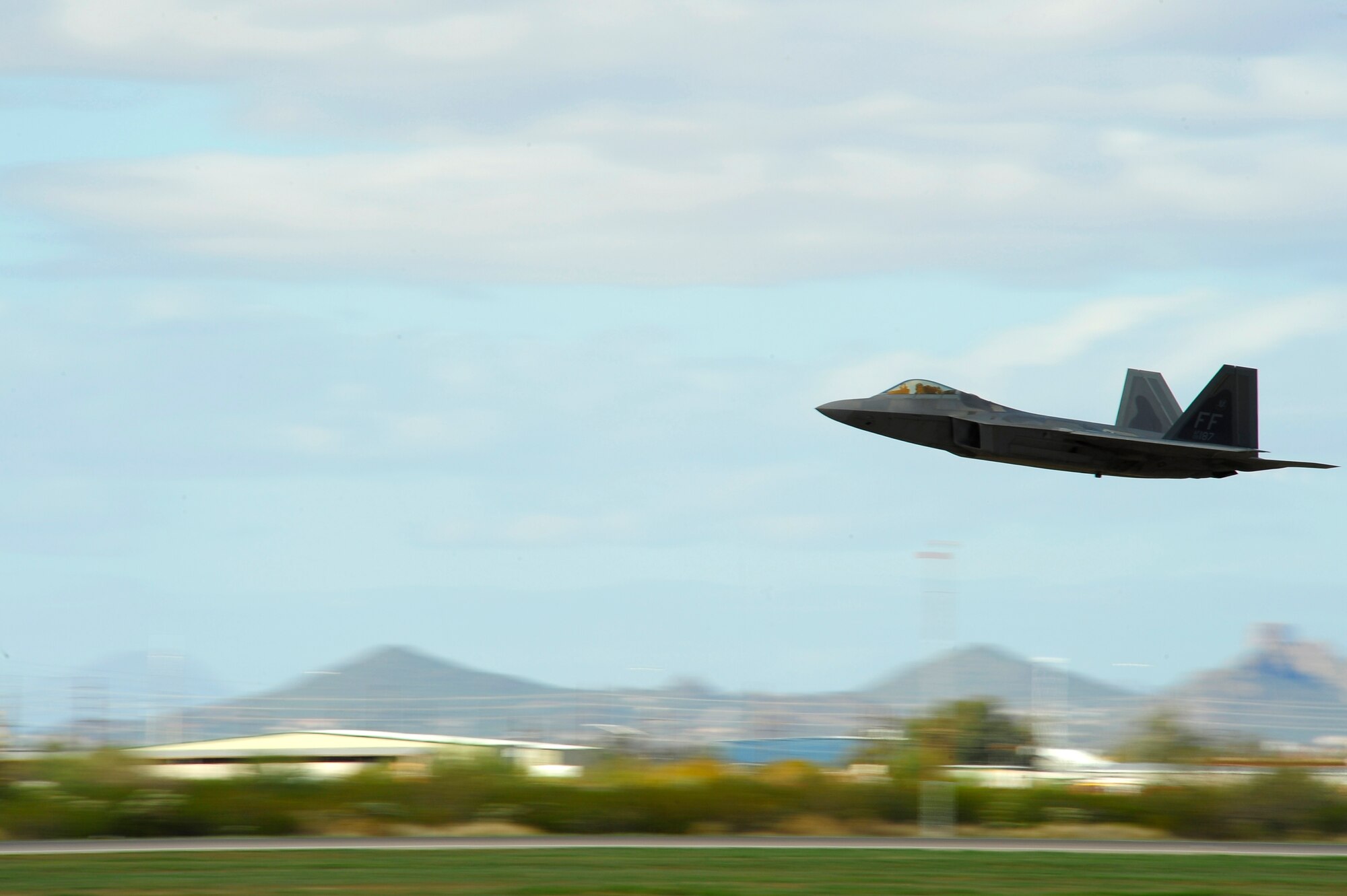 An F-22 Raptor takes off during the 2015 Heritage Flight Training and Certification Course at Davis-Monthan Air Force Base, Ariz., March 1, 2015. Established in 1997, the HFTCC featured aerial demonstrations from historical and modern fighter aircraft which will fly in formation together during air shows across the country. (U.S. Air Force photo by Tech. Sgt. Courtney Richardson/Released)
