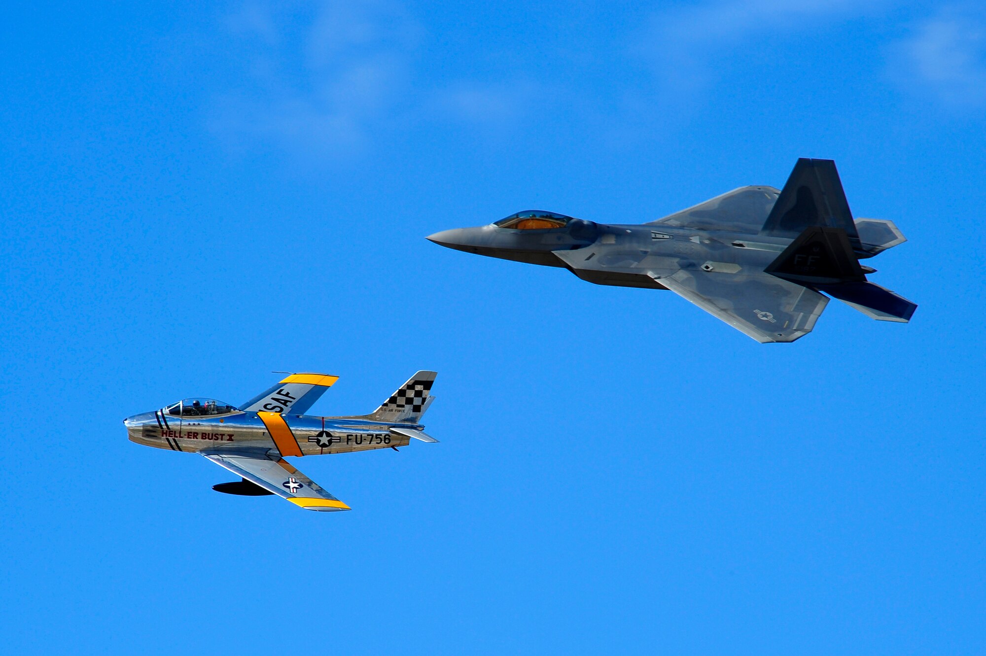 A F-86 Sabre and F-22 Raptor practice flying their aerial demonstration during the 2015 Heritage Flight Training and Certification Course at Davis-Monthan Air Force Base, Ariz., Feb. 28, 2015. The annual aerial demonstration training event has been held at D-M since 2001, providing civilian and military pilots the opportunity to practice flying in formation for the upcoming air show season. (U.S. Air Force photo by Staff Sgt. Courtney Richardson/Released)

