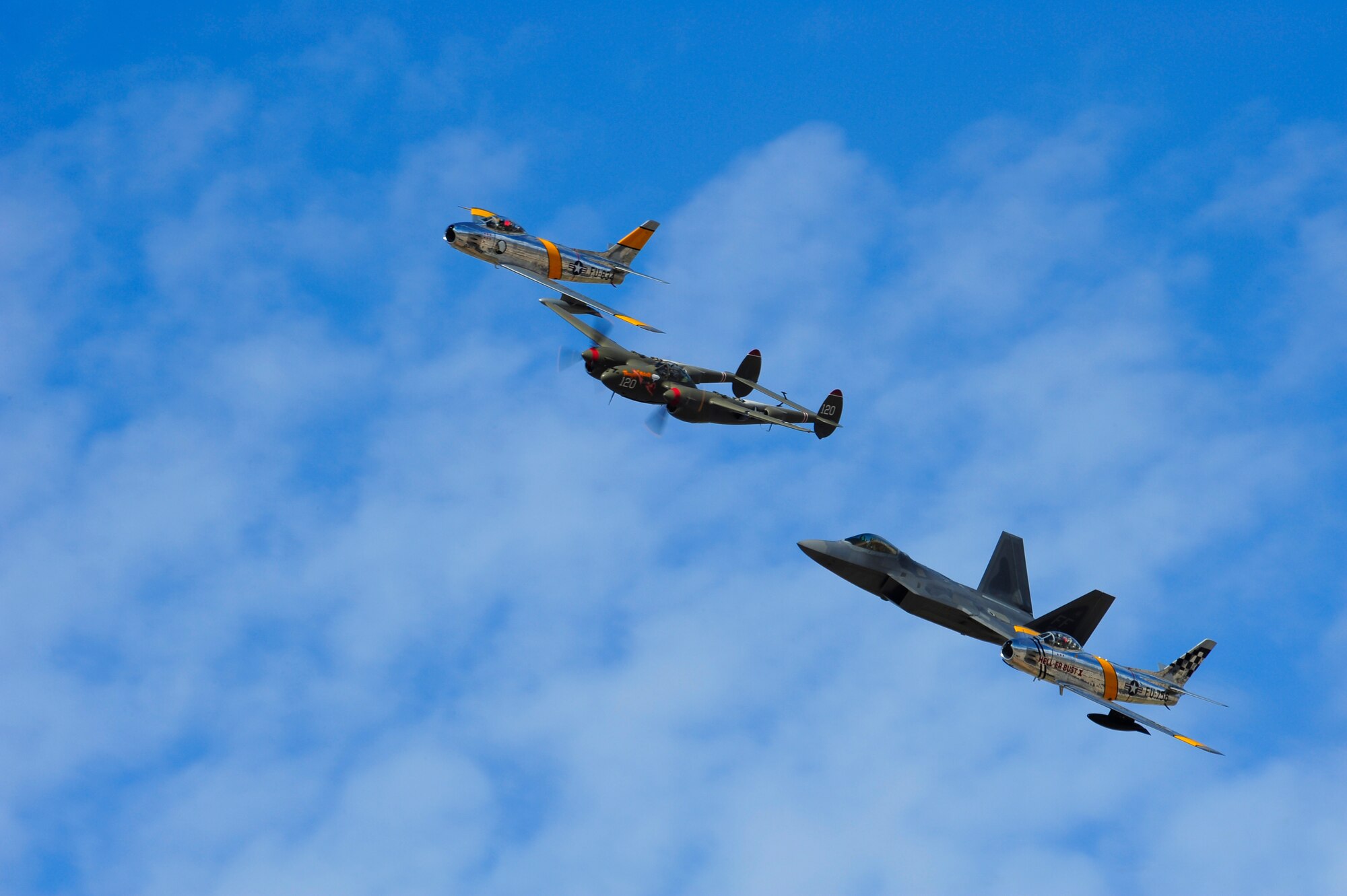 Two F-86 Sabres, a P-38 Lightning and a F-22 Raptor fly in formation together during the 2015 Heritage Flight Training and Certification Course at Davis-Monthan Air Force Base, Ariz., Feb. 28, 2015. The aircraft that participated in this year’s course were the historic P-51 Mustang, P-40 Warhawk, P-38 Lightning, P-47 Thunderbolt, F-86 Sabre, along with the current F-22 Raptor and the F-16 Fighting Falcon. (U.S. Air Force photo by Staff Sgt. Courtney Richardson/Released)
