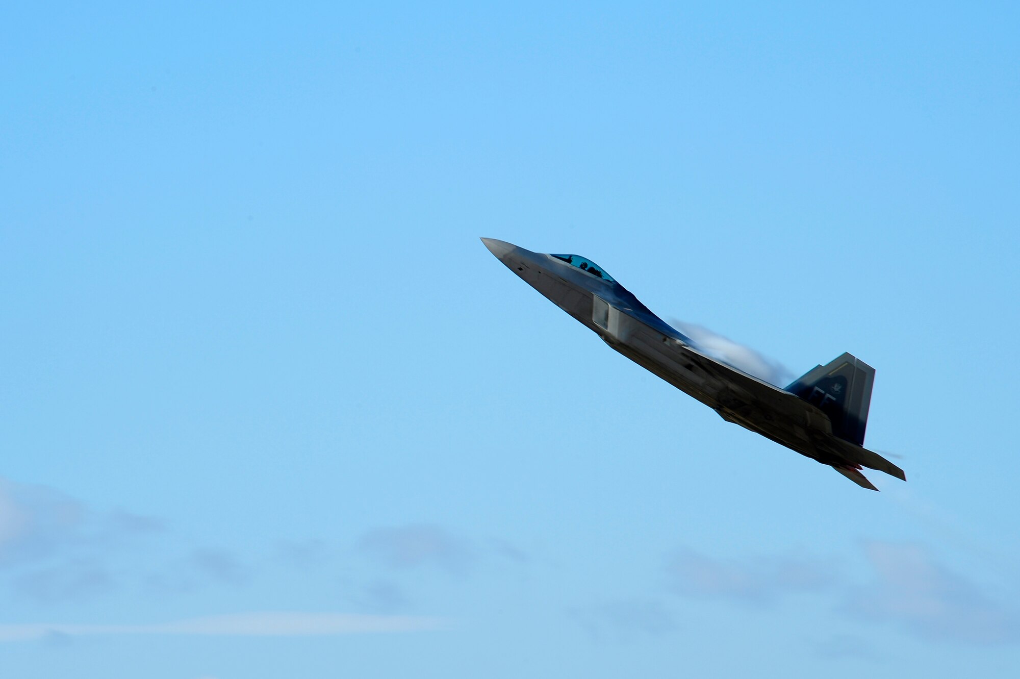 A F-22 Raptor practices his aerial demonstration during the 2015 Heritage Flight Training and Certification Course at Davis-Monthan Air Force Base, Ariz., Feb. 28, 2015. The annual aerial demonstration training event has been held at D-M since 2001, providing civilian and military pilots the opportunity to practice flying in formation for the upcoming air show season. (U.S. Air Force photo by Staff Sgt. Courtney Richardson/Released)
