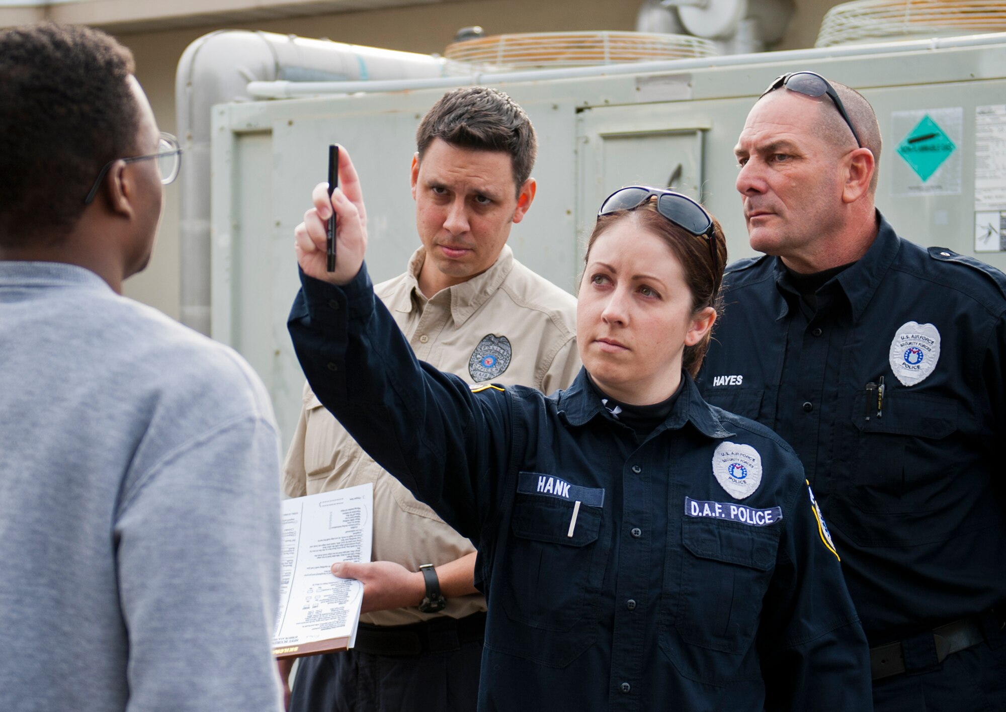 Officers Janine Hank, Mike Hayes and Lawrence Holst judge the intoxication level of an inebriated volunteer during a 96th Security Forces training session Feb. 27. A horizontal gaze nystagmus test evaluates involuntary jerking of the eye while “walk and turn” and standing on one leg exercises evaluates coordination. This is the first time the class was hosted on base by Escambia County law enforcement to help Eglin Defenders test the skills, compare their judgment to breathalyzer scores and learn new techniques.  (U.S. Air Force photo/Chrissy Cuttita)  