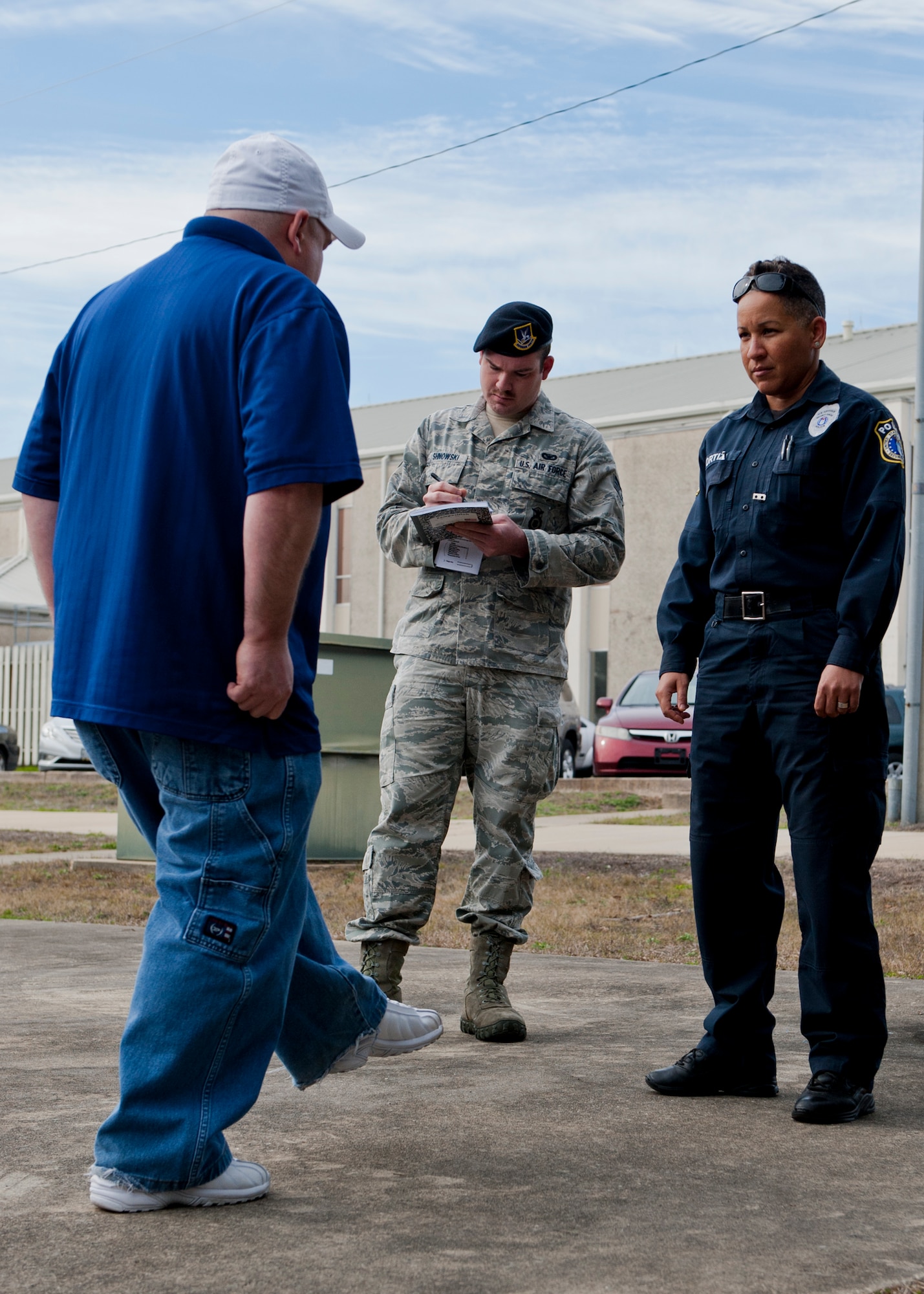 Officer Maria Ortiz and Senior Airman Dylan Shnowski judge the intoxication level of an inebriated volunteer during a 96th Security Forces training session here Feb. 27. Having a suspect standing on one leg gives security police an opportunity to evaluate if an individual’s coordination is impaired during a routine traffic stop. This is the first time the class was hosted on base by Escambia County law enforcement to help Eglin Defenders test the skills, compare their judgment to breathalyzer scores and learn new techniques.  (U.S. Air Force photo/Chrissy Cuttita)  