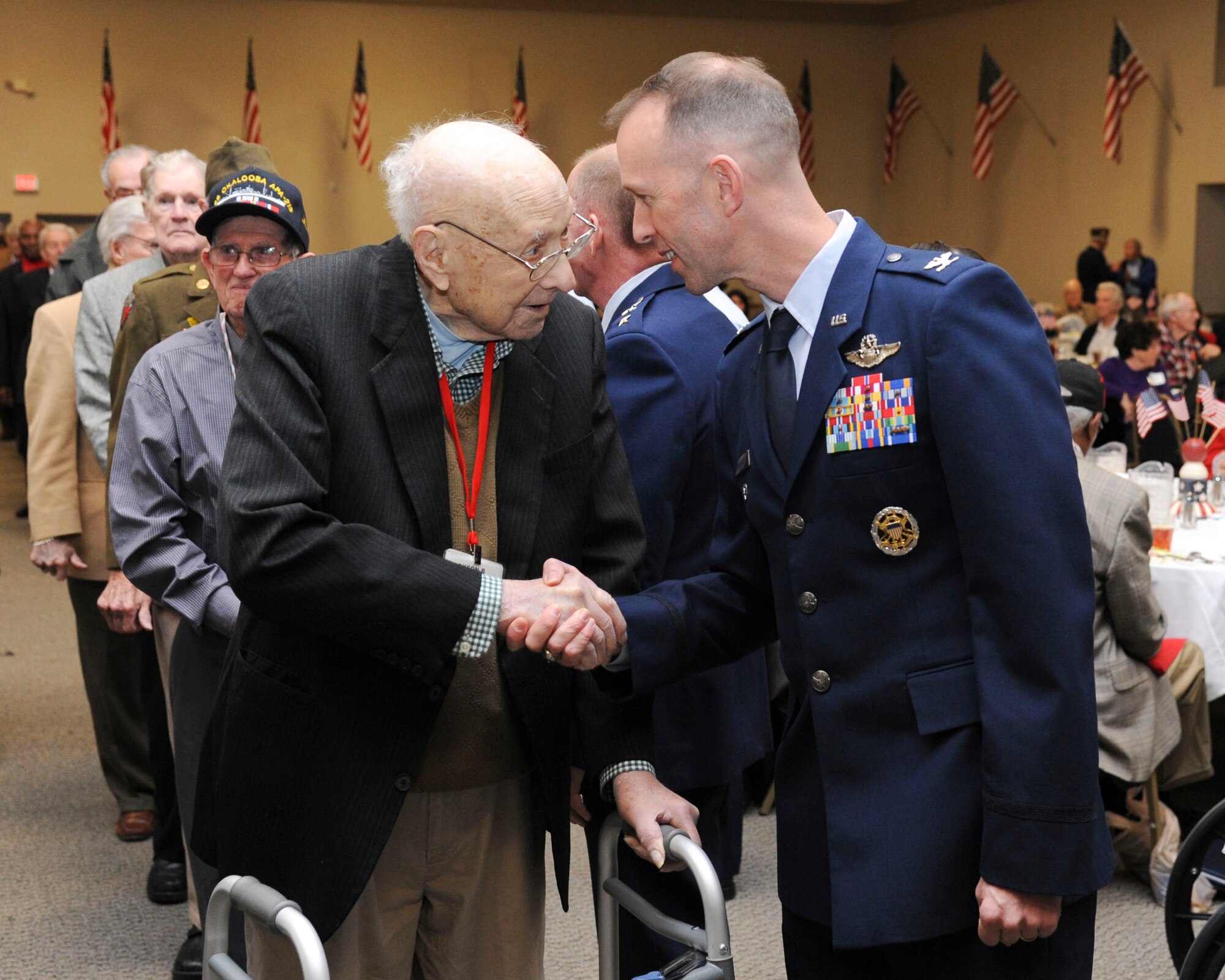 Col. Leland Bohannon, 2nd Bomb Wing vice commander, greets a World War II veteran during the WWII luncheon on Barksdale Air Force Base, La., Feb. 27, 2015. Local veterans from all services were invited to this annual event and were honored for their contributions during the war. (U.S. Air Force photo/ Senior Airman Jannelle Dickey)