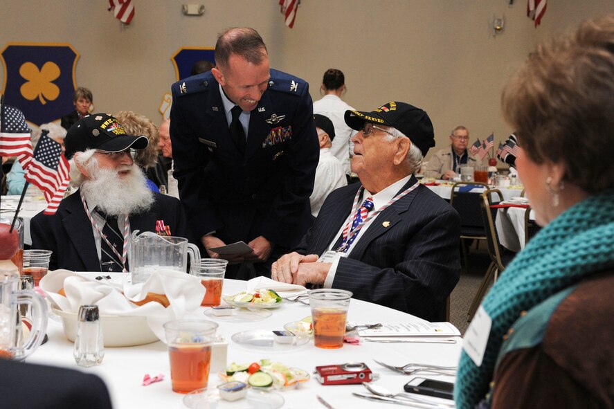 Col. Leland Bohannon, 2nd Bomb Wing vice commander, greets World War II veterans during the WWII luncheon on Barksdale Air Force Base, La., Feb. 27, 2015.  The annual luncheon was held to honor those who served in the armed forces during the war. (U.S. Air Force photo/ Senior Airman Jannelle Dickey)